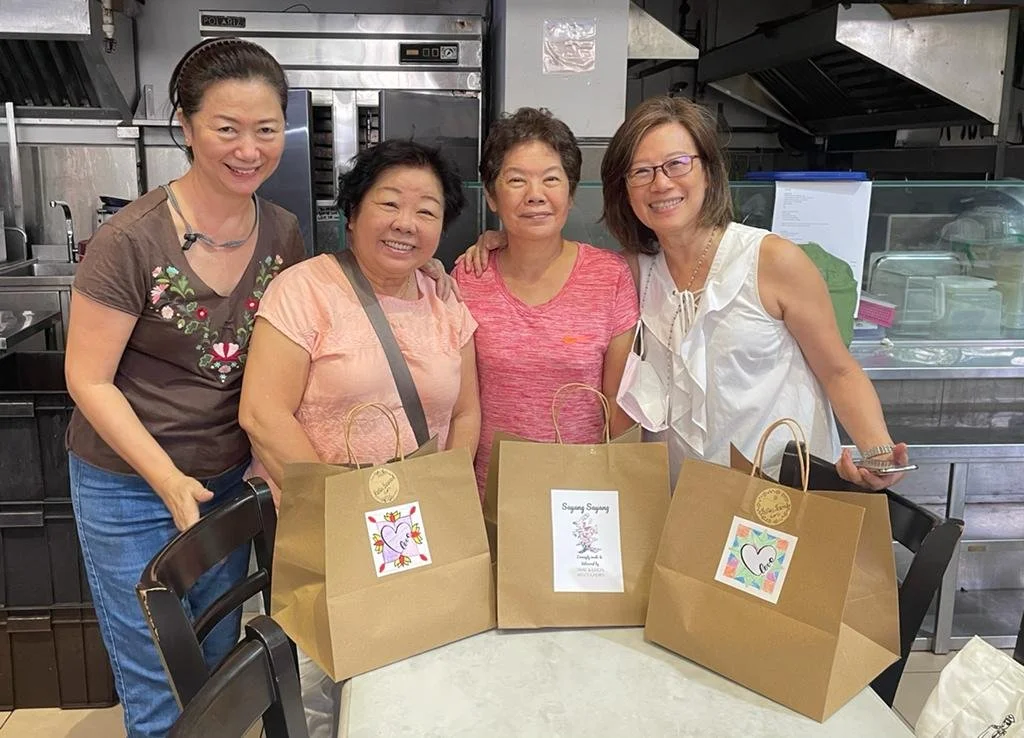 WSCS four women with gift bags at a cafeteria 1024x738.JPG