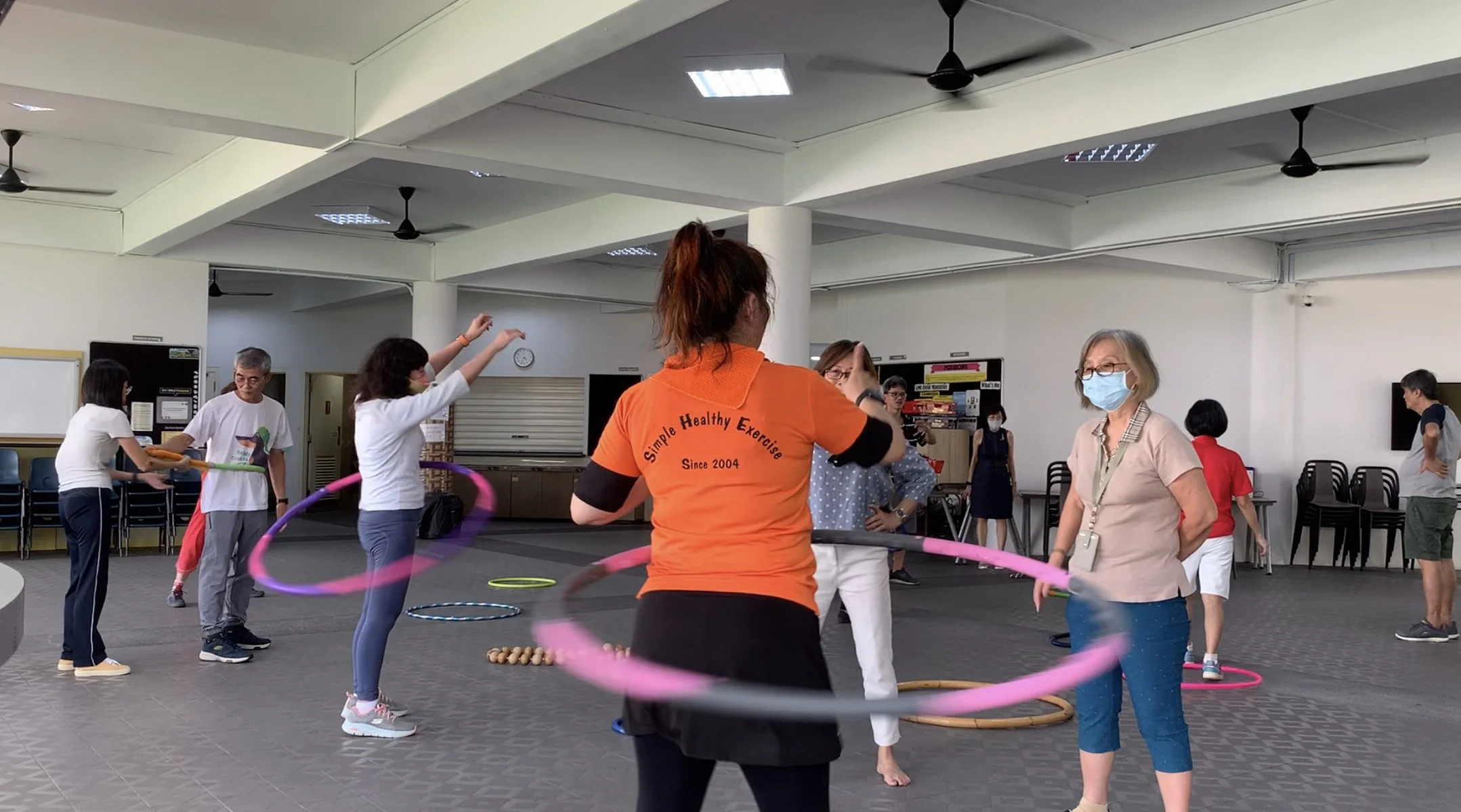 WSCS exercise instructors with hoops at Aldersgate Chapel social hall 2157x1200.JPG
