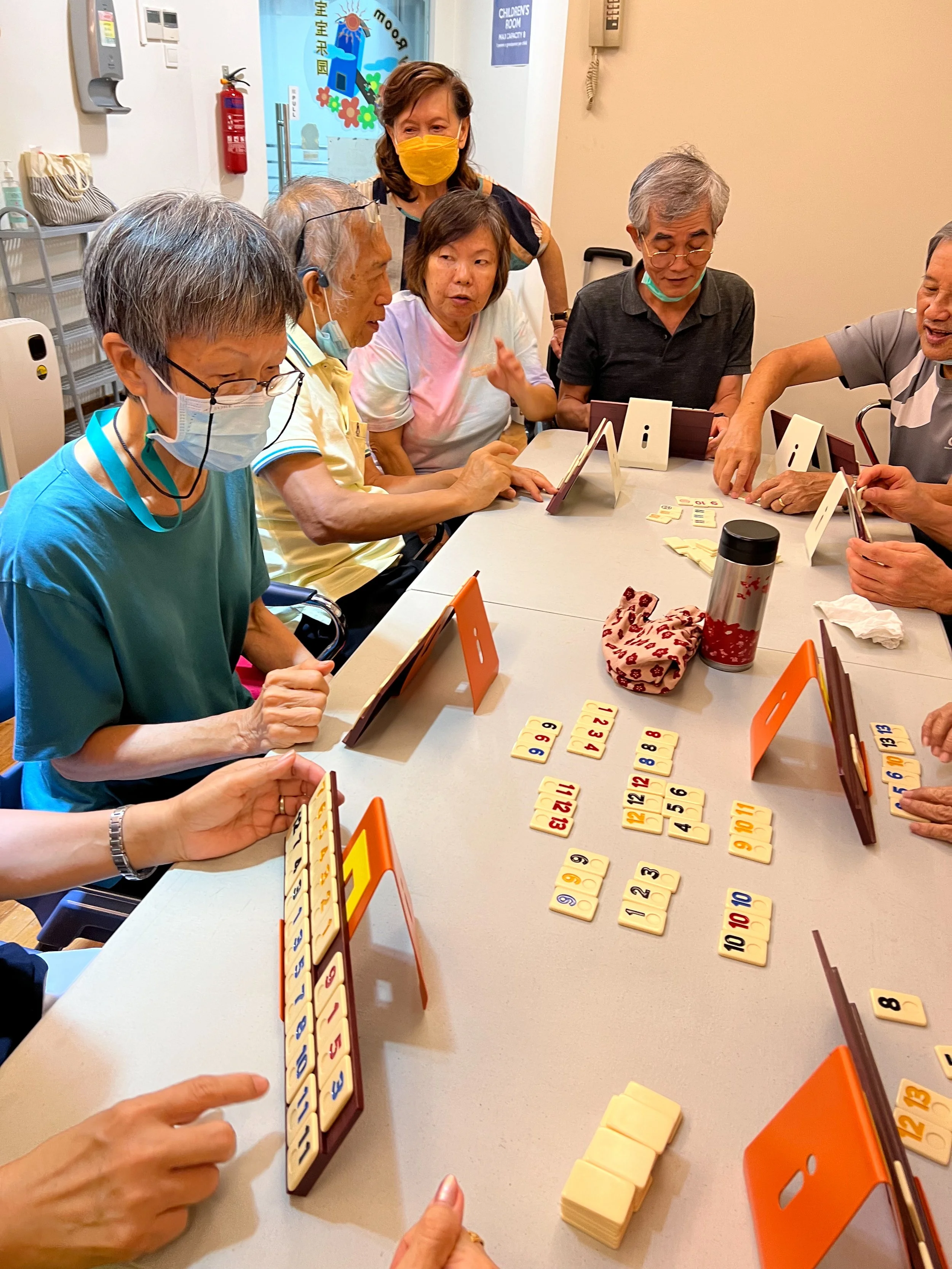 Caleb85 group gathering playing Rummikub centred on table 3024x4032.jpg