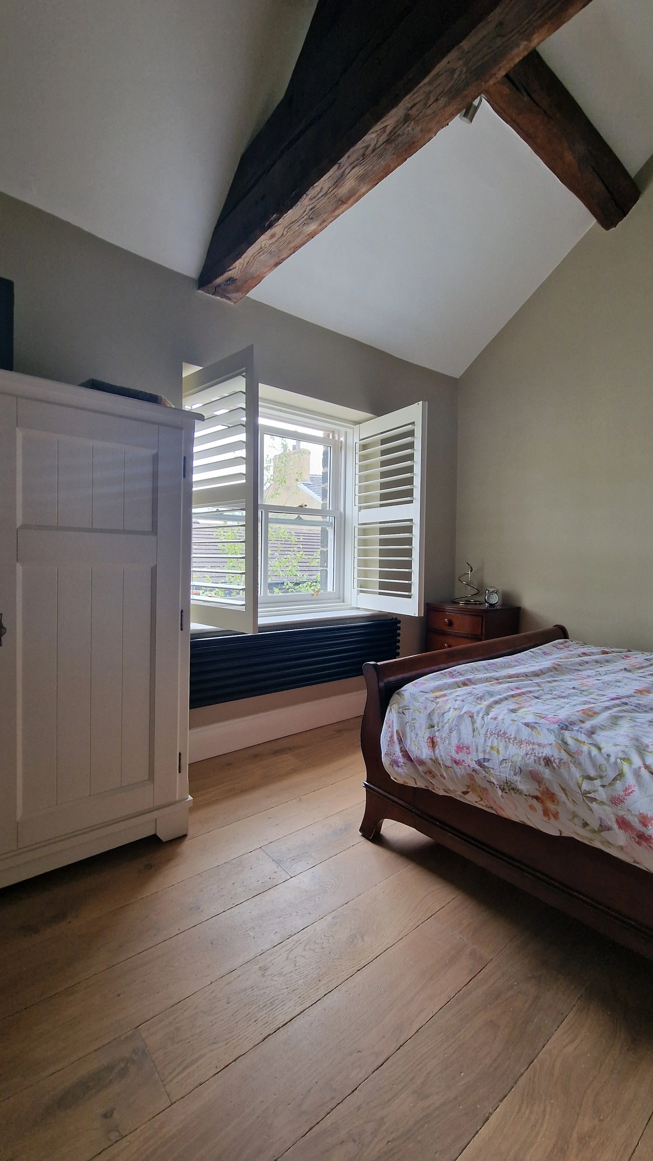 bedroom with solid wood plank flooring