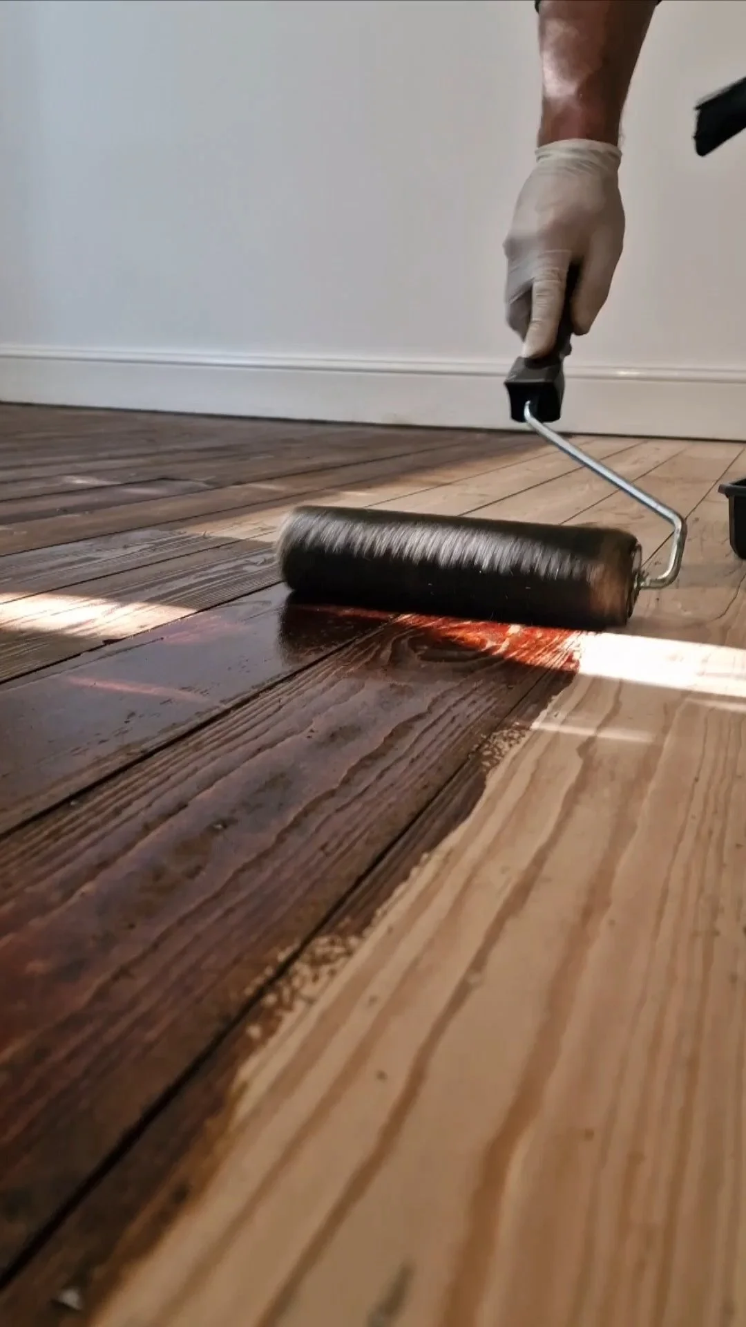 Sanded wood floor being stained