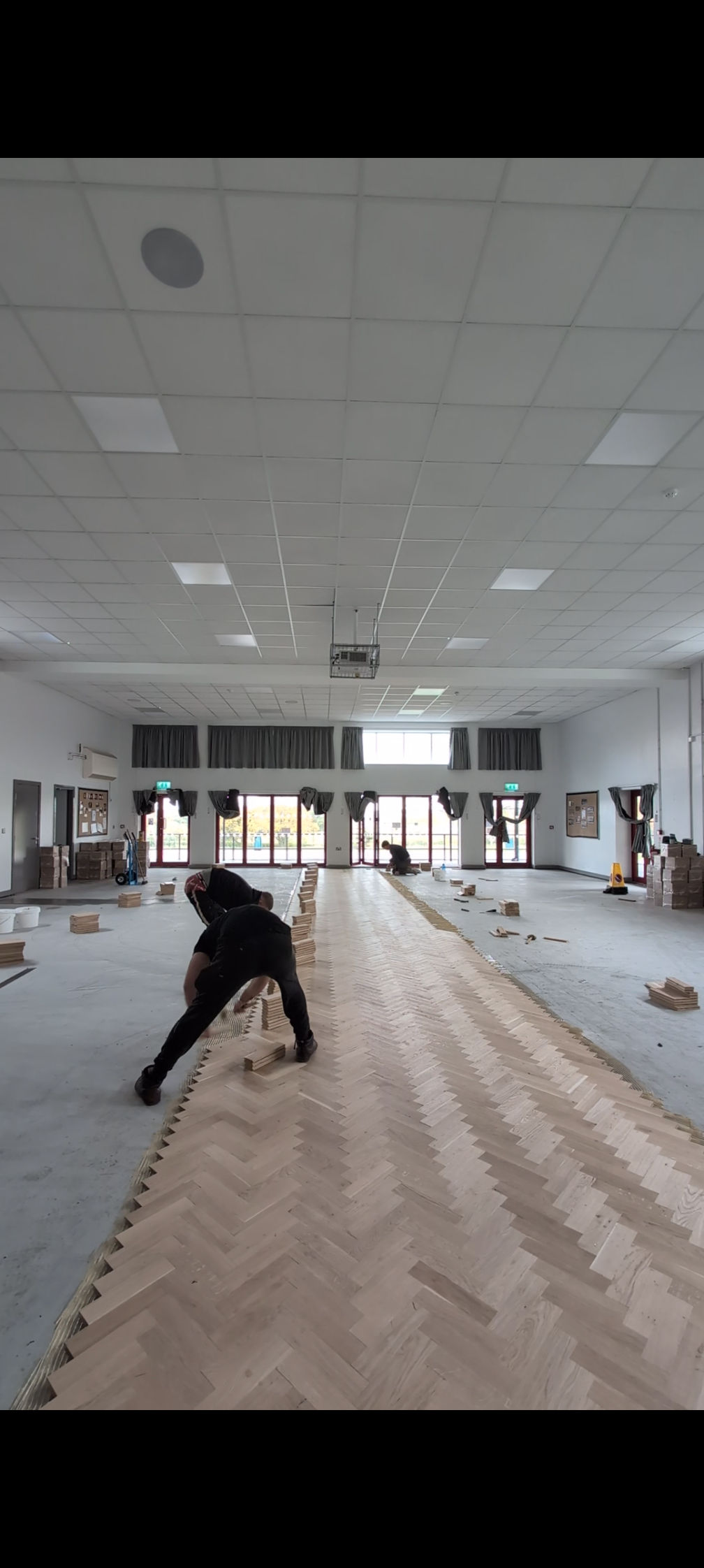 Herringbone flooring being installed in a school