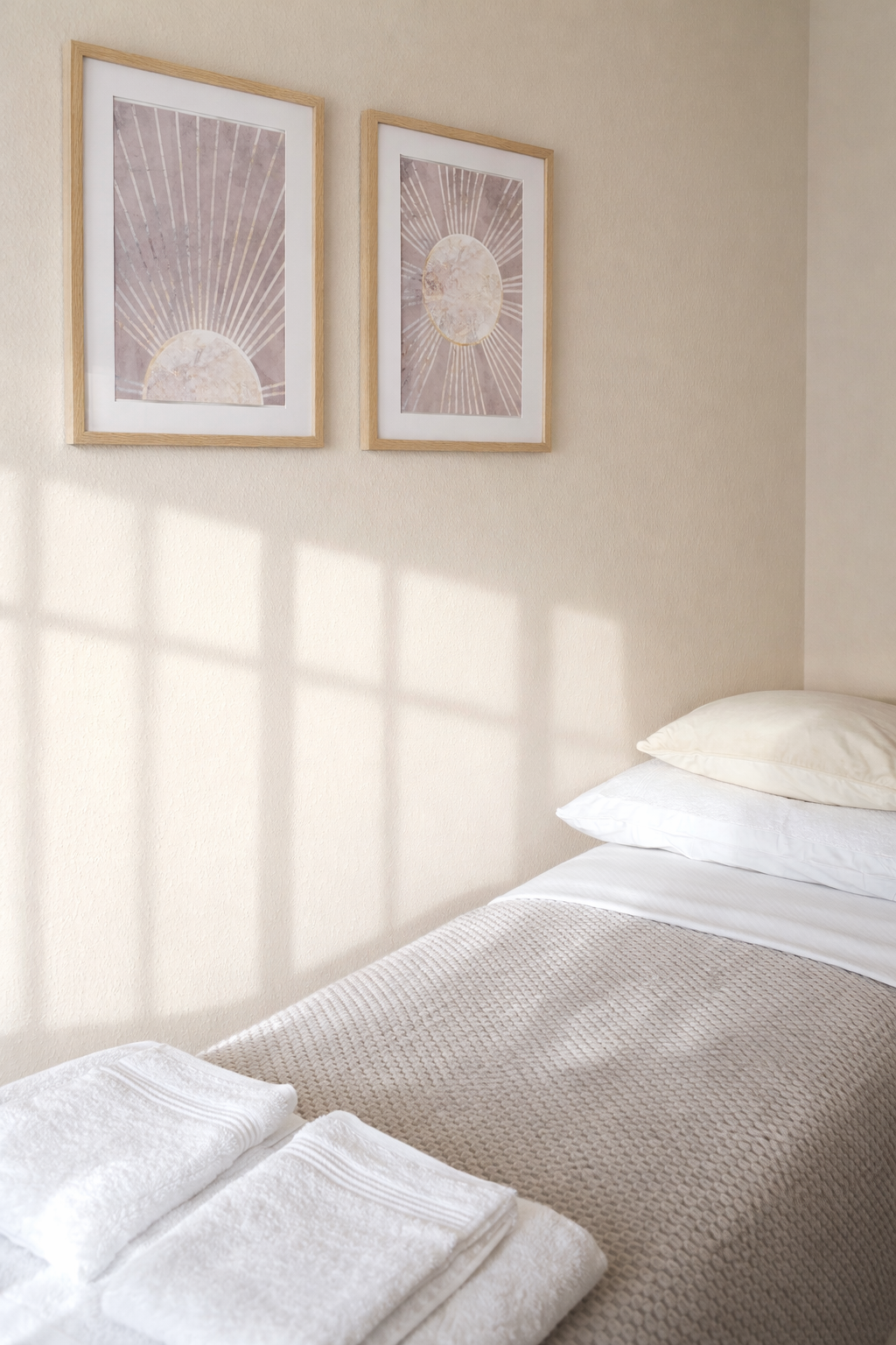 Neatly arranged bedroom with sunburst art.png