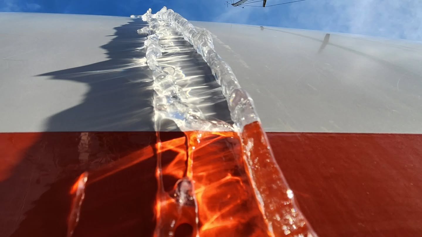 Frozen tendrils of ice cling to my sailboat as it sits stoically in the boatyard, a striking contrast to the vibrant dreams of adventure that live in my head. The ice may hold us captive for now, but spring will soon break its grip, and with it, the 