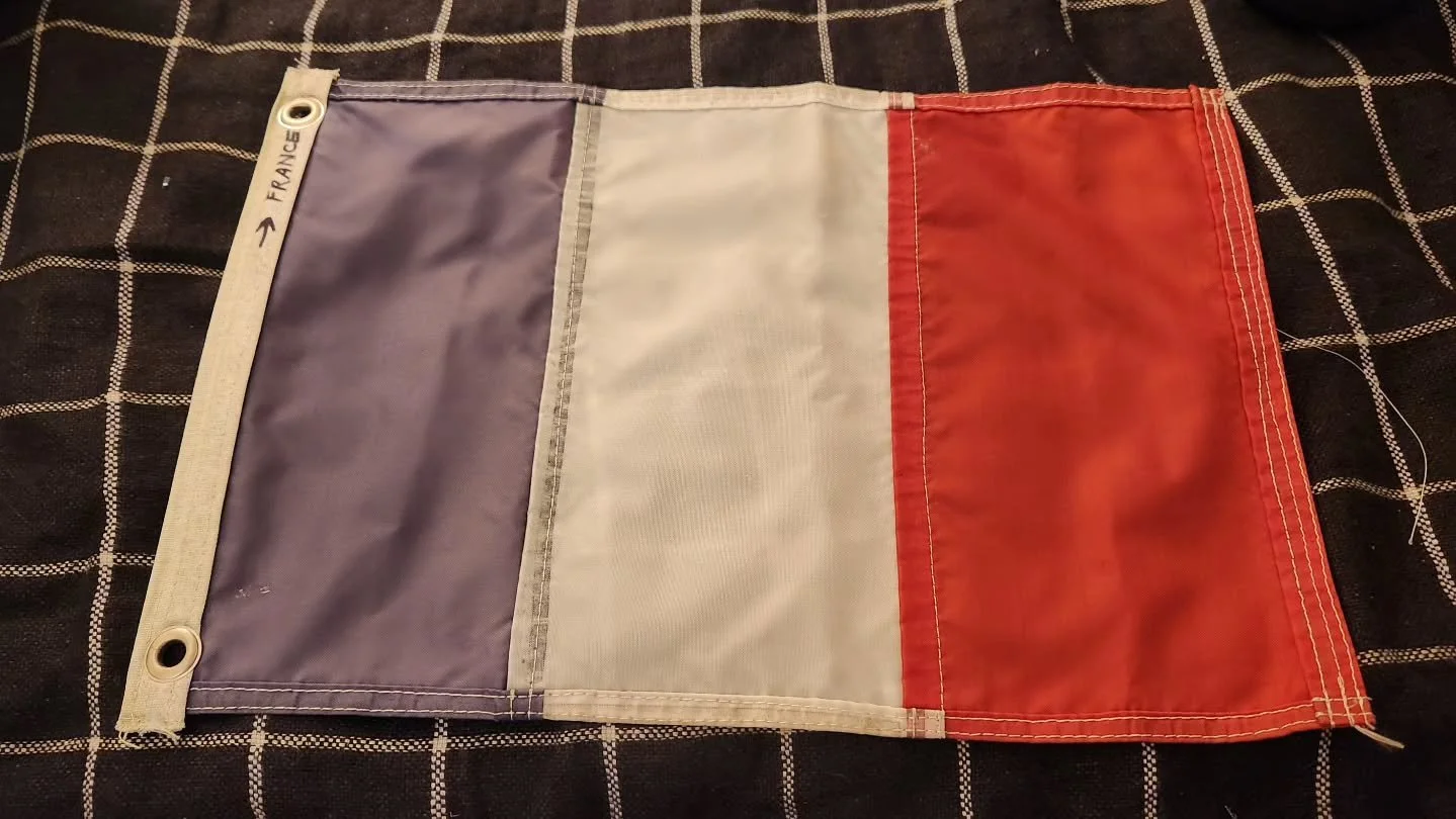I sewed this flag a year ago, and it's been flying on Mary Waters in the boat yard ever since. I'm having the rigging replaced so it's been taken down. Aside from my wavy seam lines (I'm getting better), it's in decent shape. The blue has faded to a 
