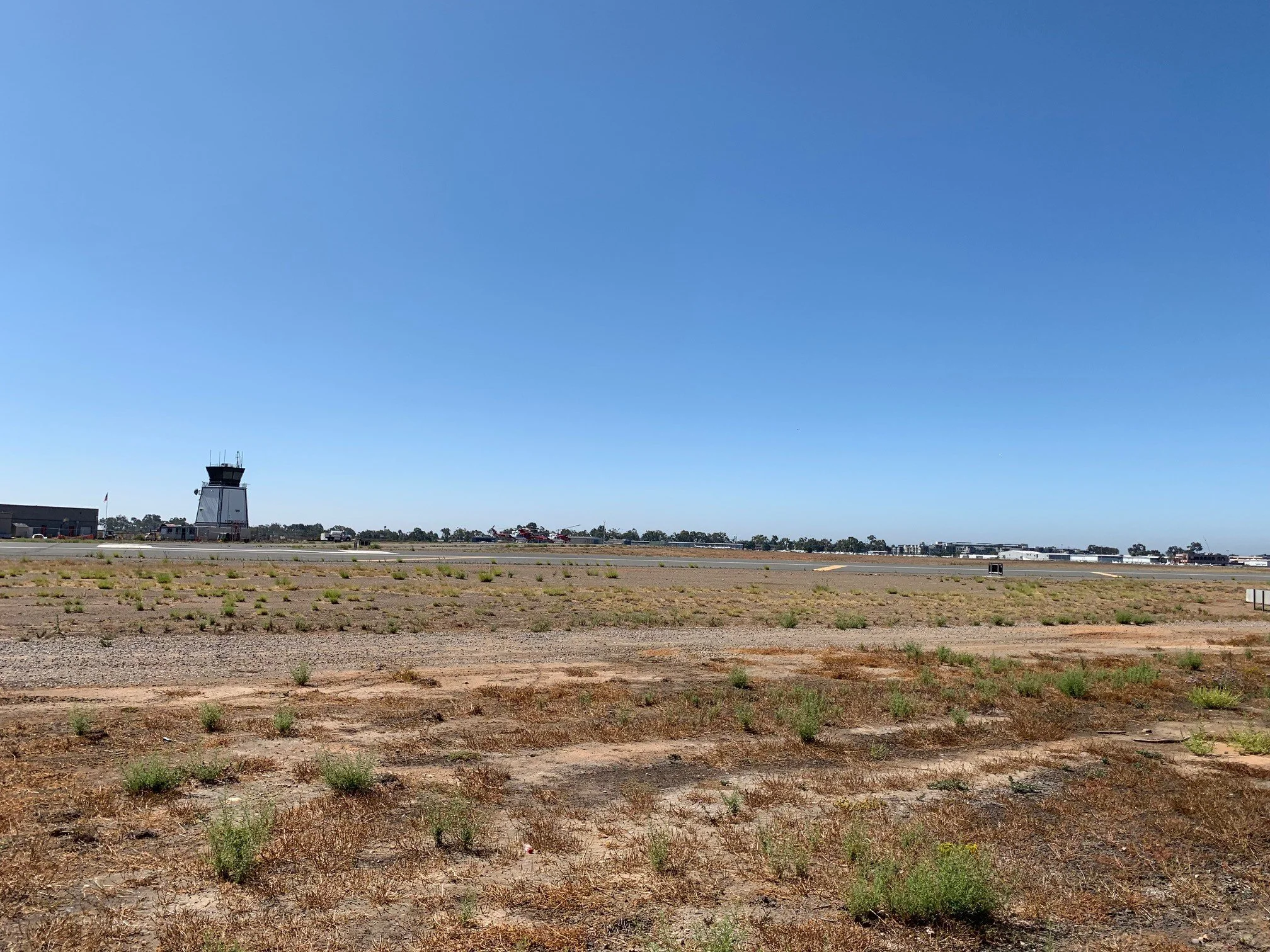 Airport control tower and runway with clear blue sky
