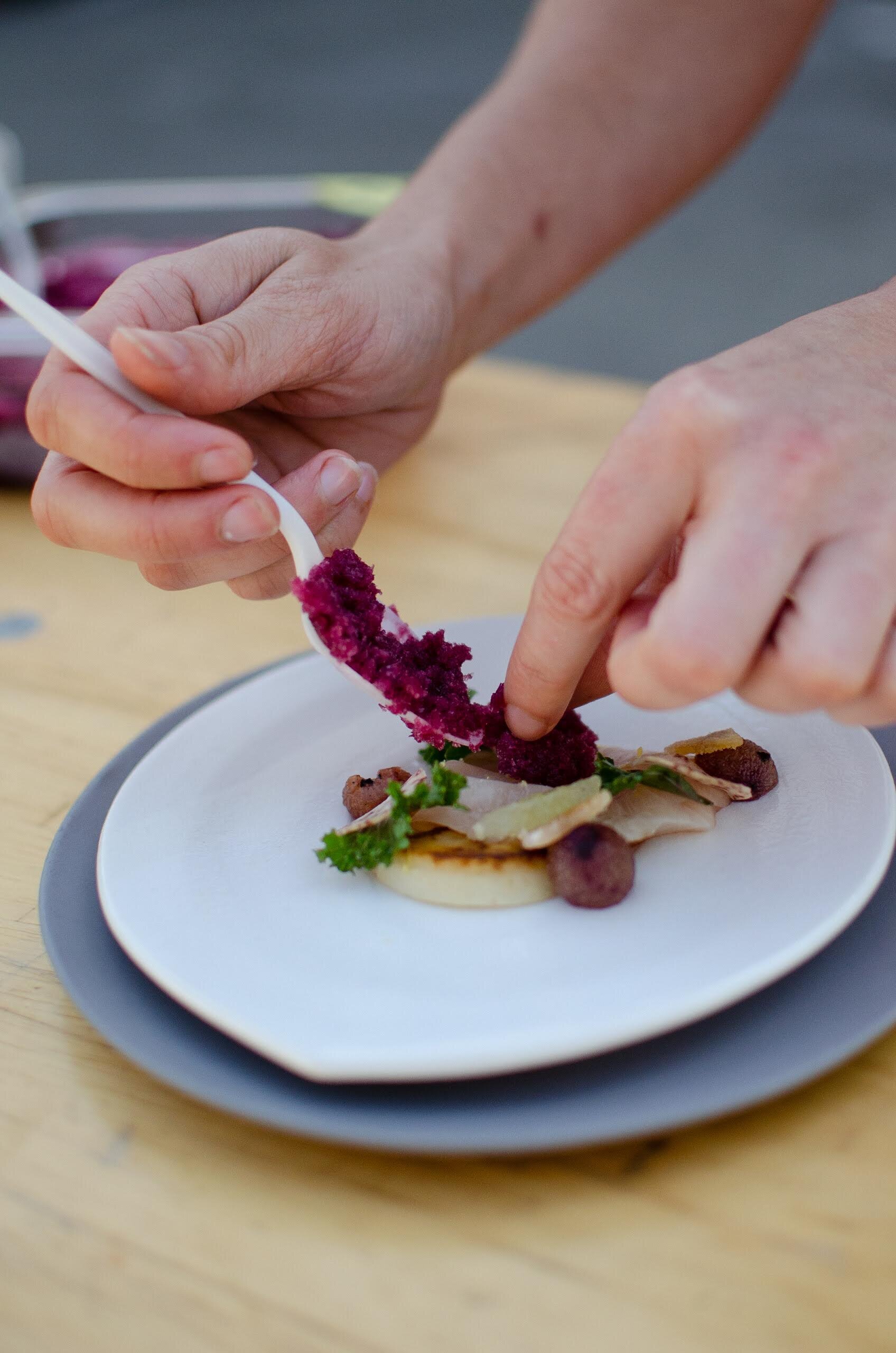  Chef plating a composed winter crudo with a granita 