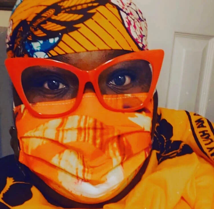 Annie’s “Orange Volcano Spiral” mask on Artist Tufara Waller Muhammad.   Click photo to buy  Face Masks by Annie.