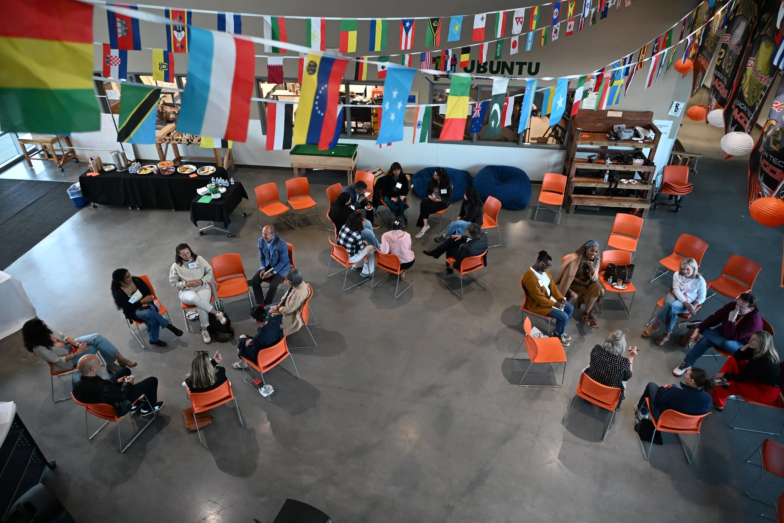 3 circles of people sitting in chairs, discussing