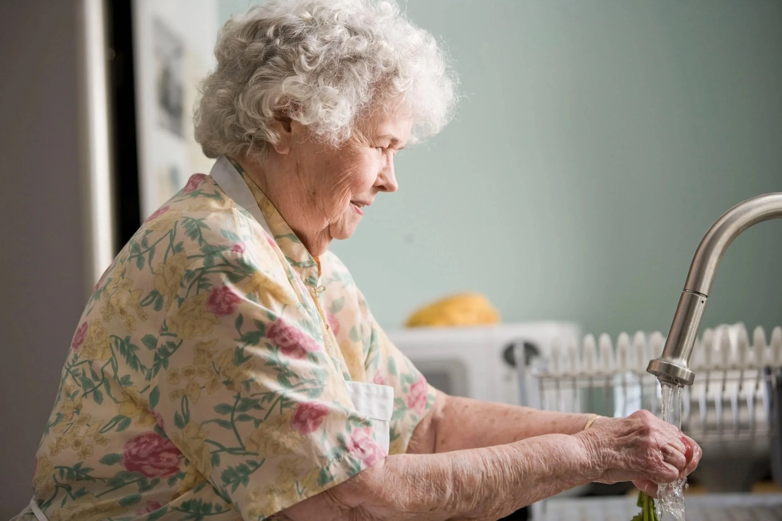 Older woman washing her hands