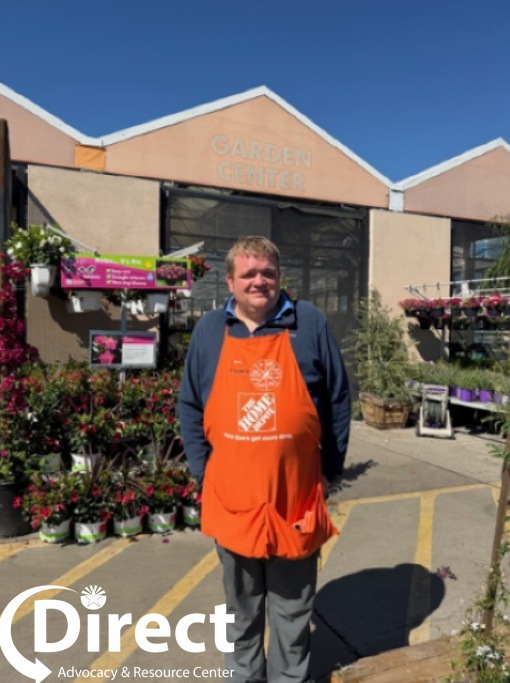Forrest  standing outside the garden center wearing his Home Depot Apron