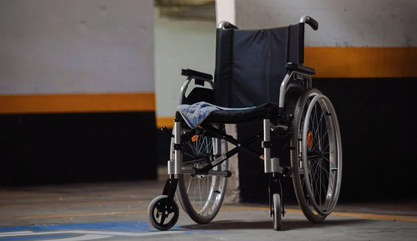 An unoccupied wheelchair in a sports arena
