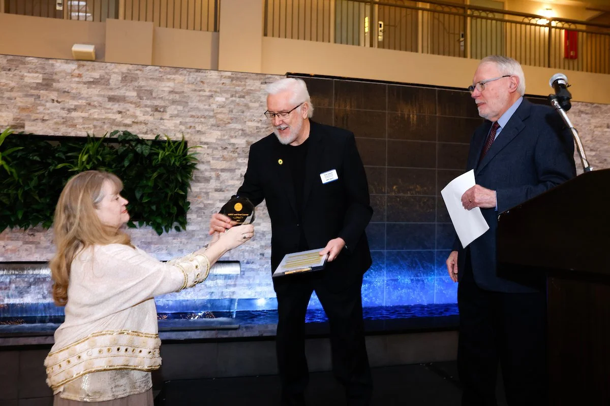 WashCOG Executive Director Colette Weeks, left, gives the James Andersen Award to Tom Layson and KBTC, with President Mike Fancher, right, at the Washington Coalition for Open Government Sunshine Breakfast on March 13, 2026. -- Photo by Karen Ducey, 