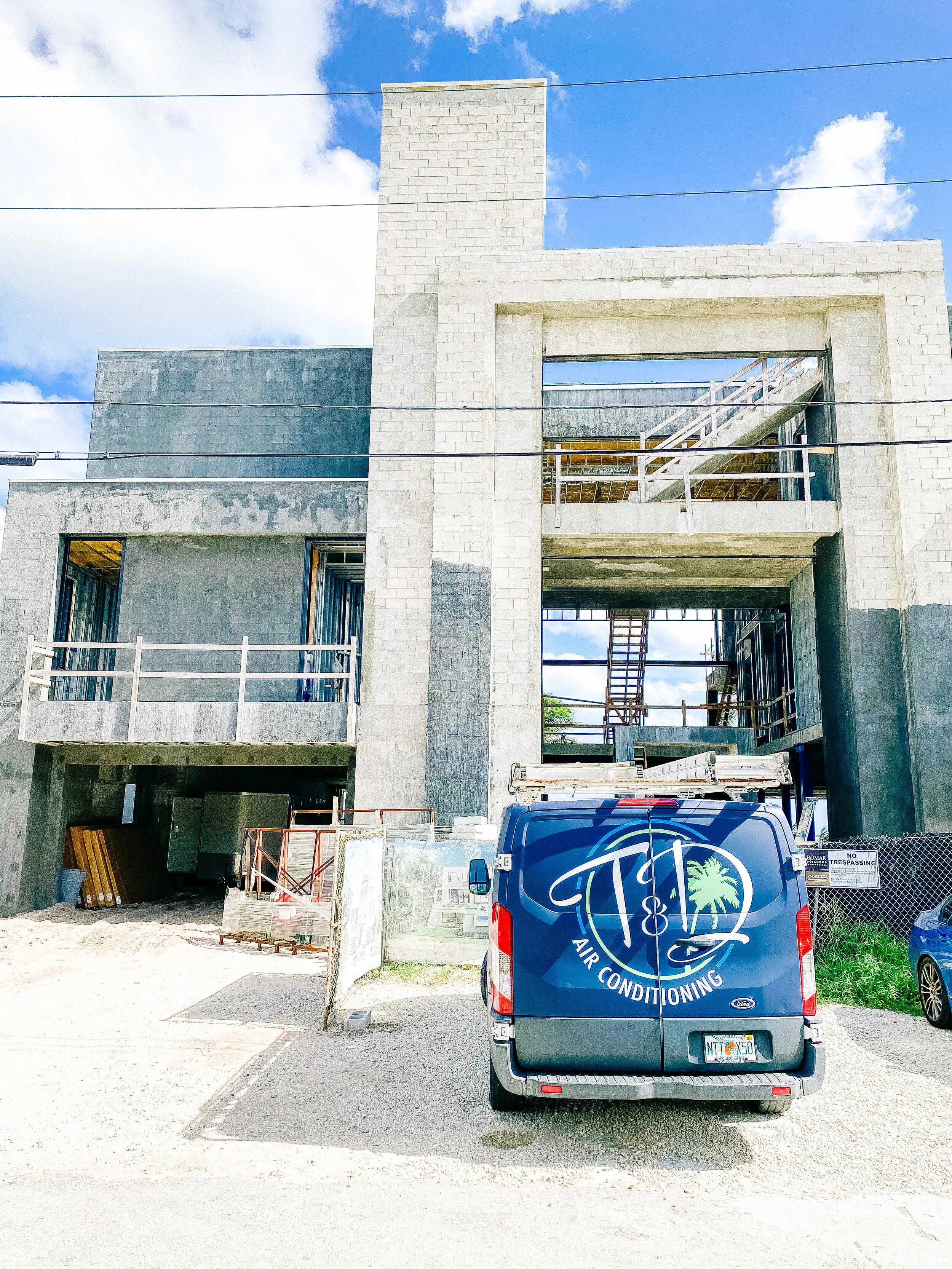 T & D Air Conditioning van at a construction site performing HVAC system installation in South Florida