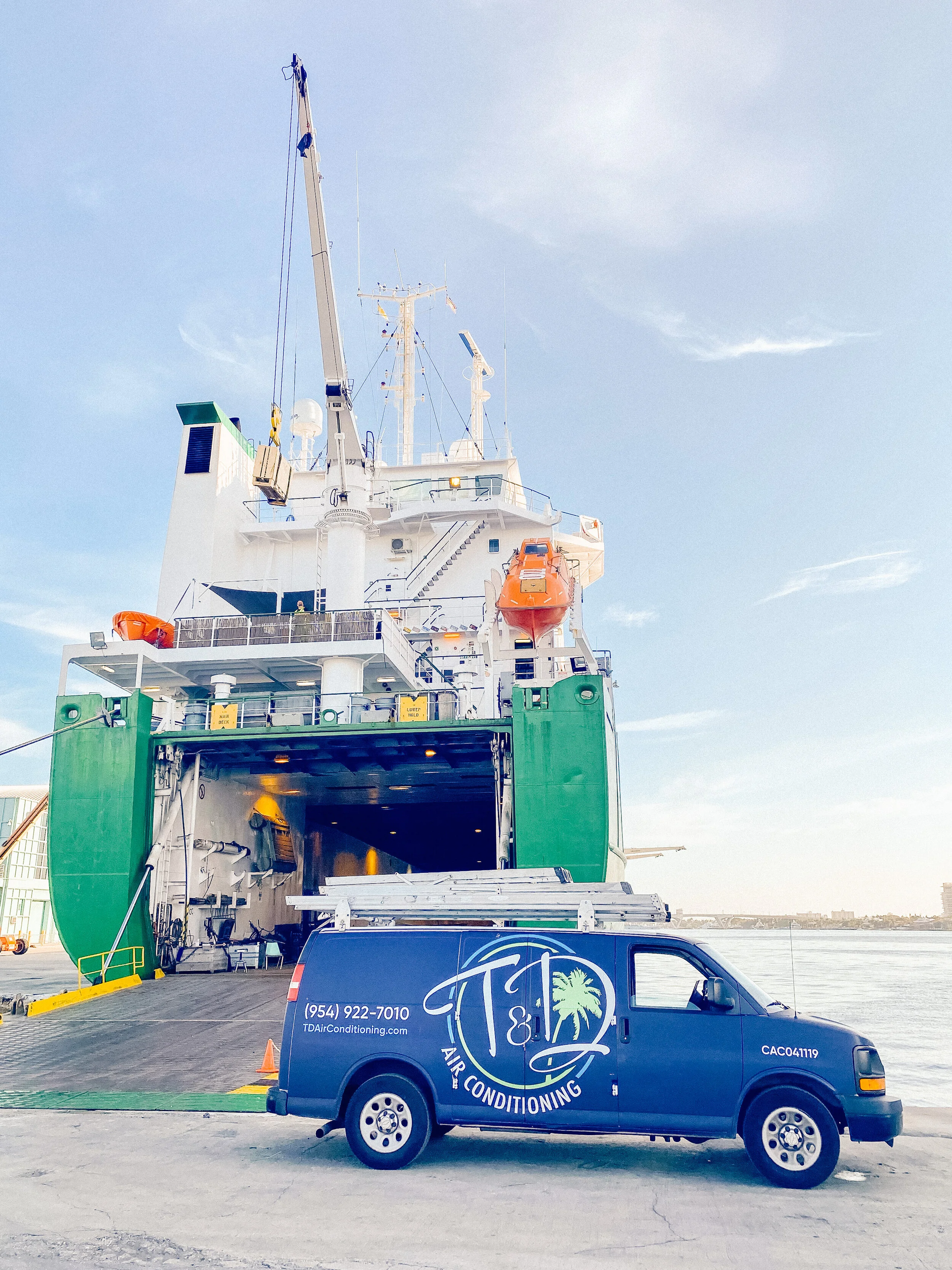 T & D Air Conditioning service van at a commercial port location providing HVAC services in South Florida