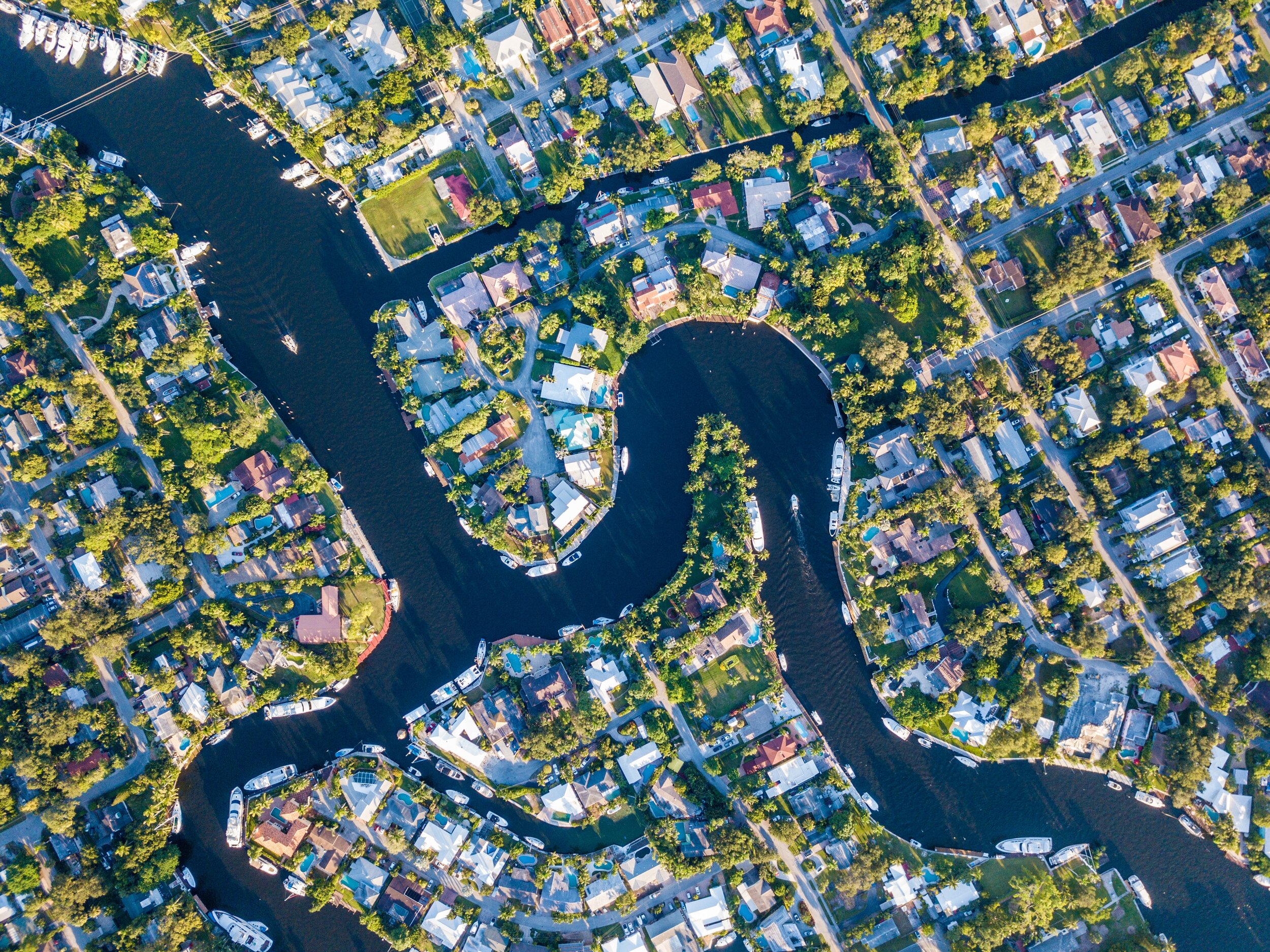 Aerial view of waterfront homes along canals in South Florida residential neighborhoods