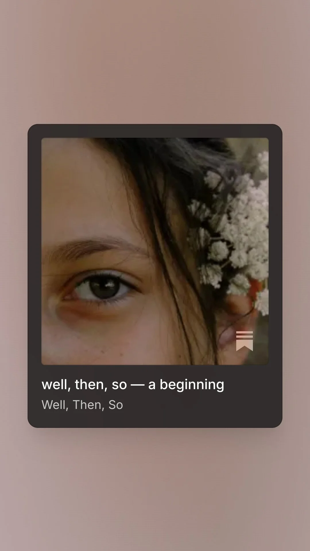 Close-up of part of a person's face with an eye, brown hair, and white flowers behind the ear against a pink background.