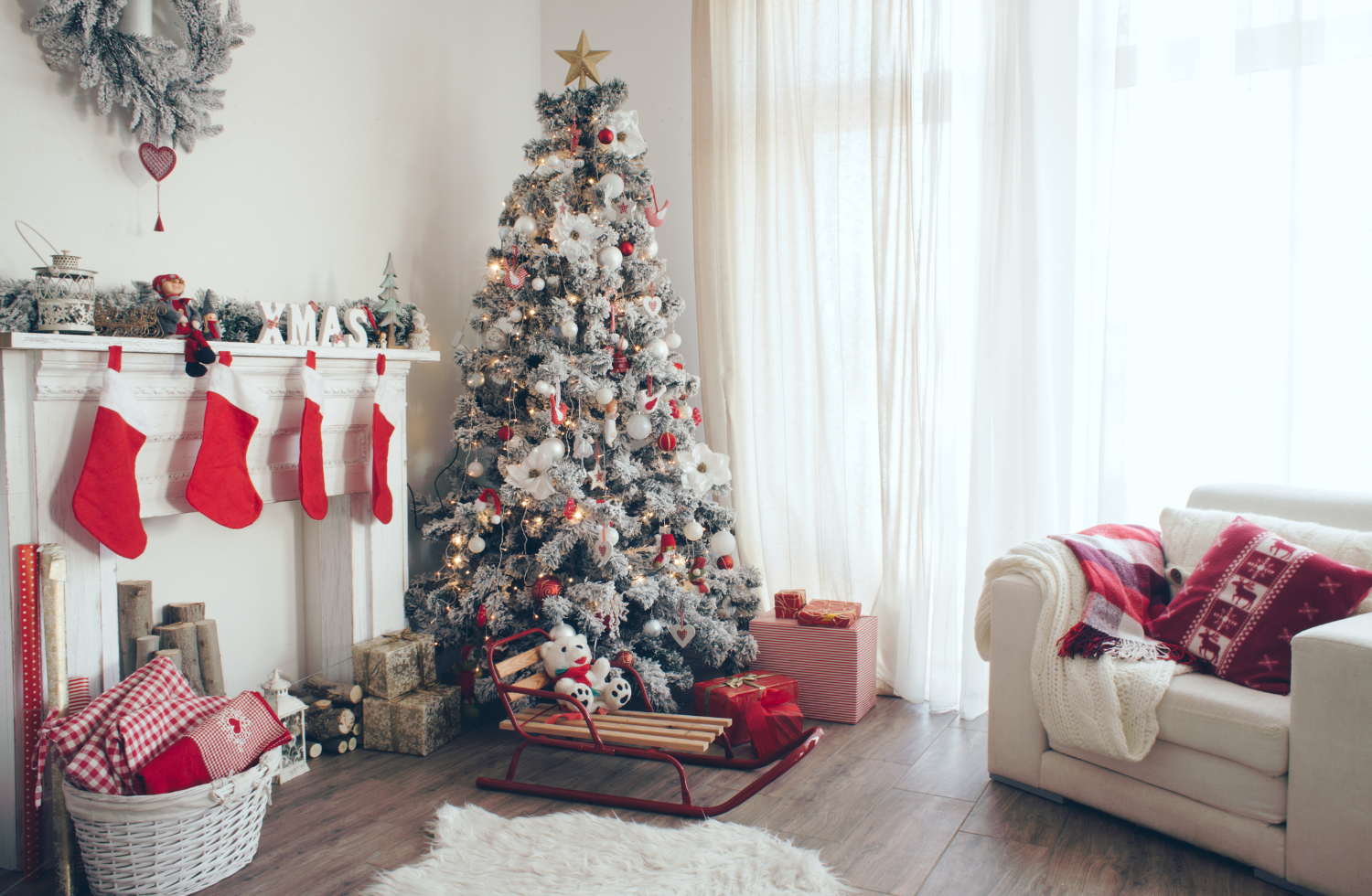 Red and white Christmas tree with stockings hung by the fireplace - 6 Tips for Getting Your Home Ready for the Holidays