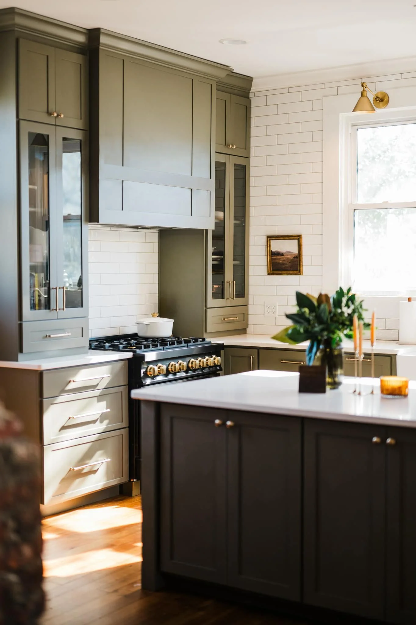 A kitchen with Cocoon green cabinets, shaker-style doors.