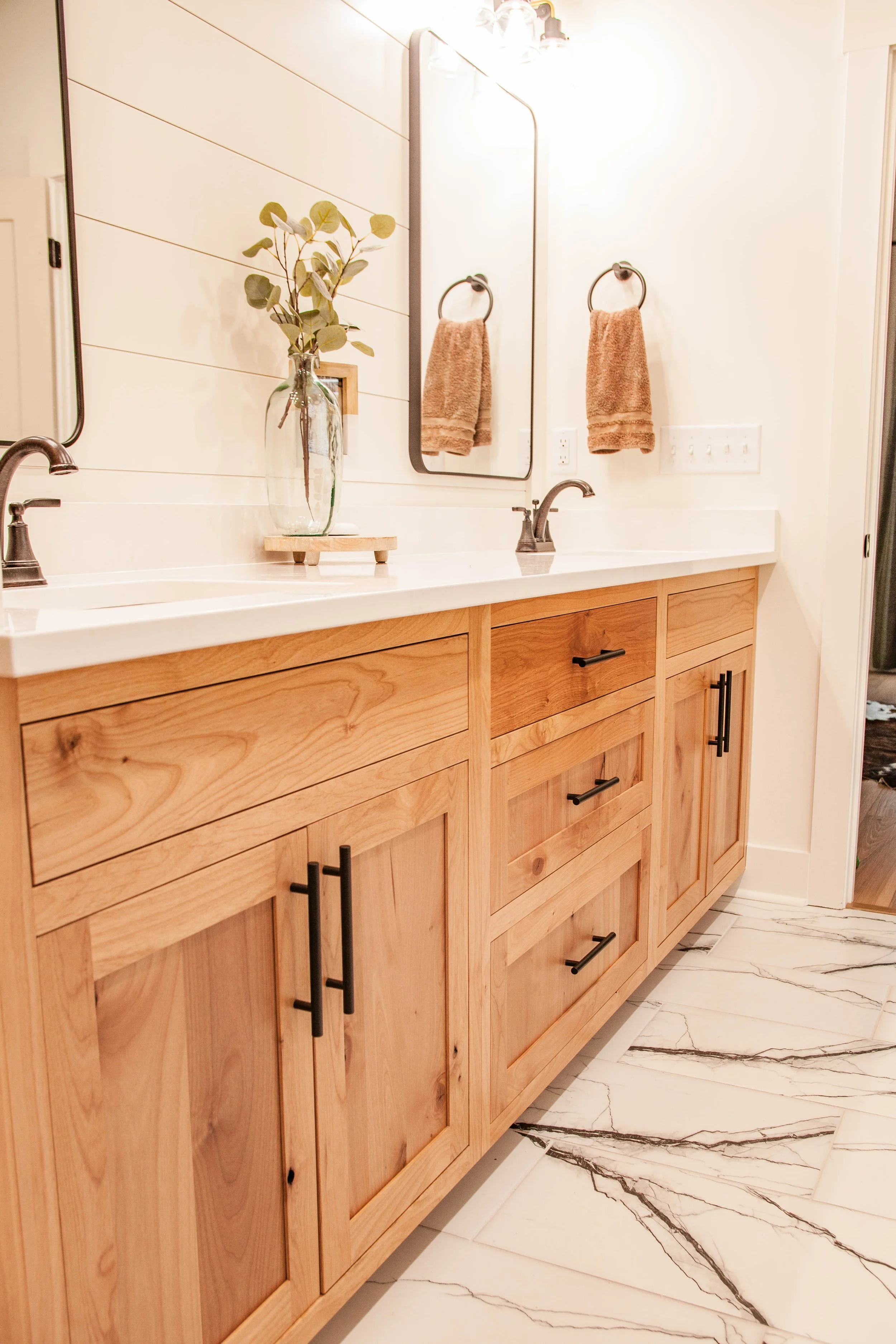 A bathroom vanity with Alder wood cabinets, inset shaker-style doors.