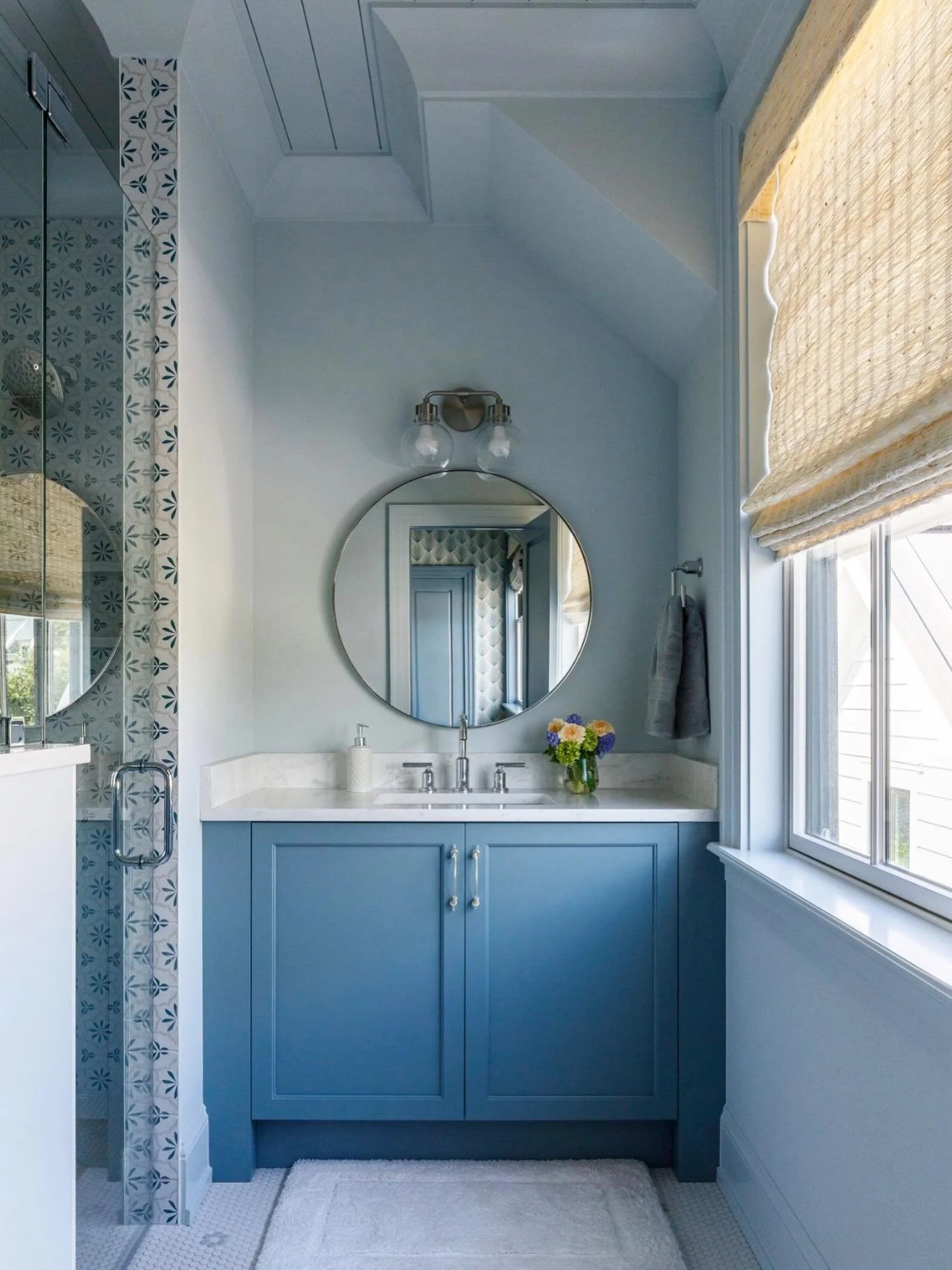 There&rsquo;s something about a soft blue palette that instantly brings a sense of calm. Paired with delicate patterned tile, natural woven shades, and crisp white finishes, this bath feels like a breath of fresh air&mdash;light, airy, and effortless