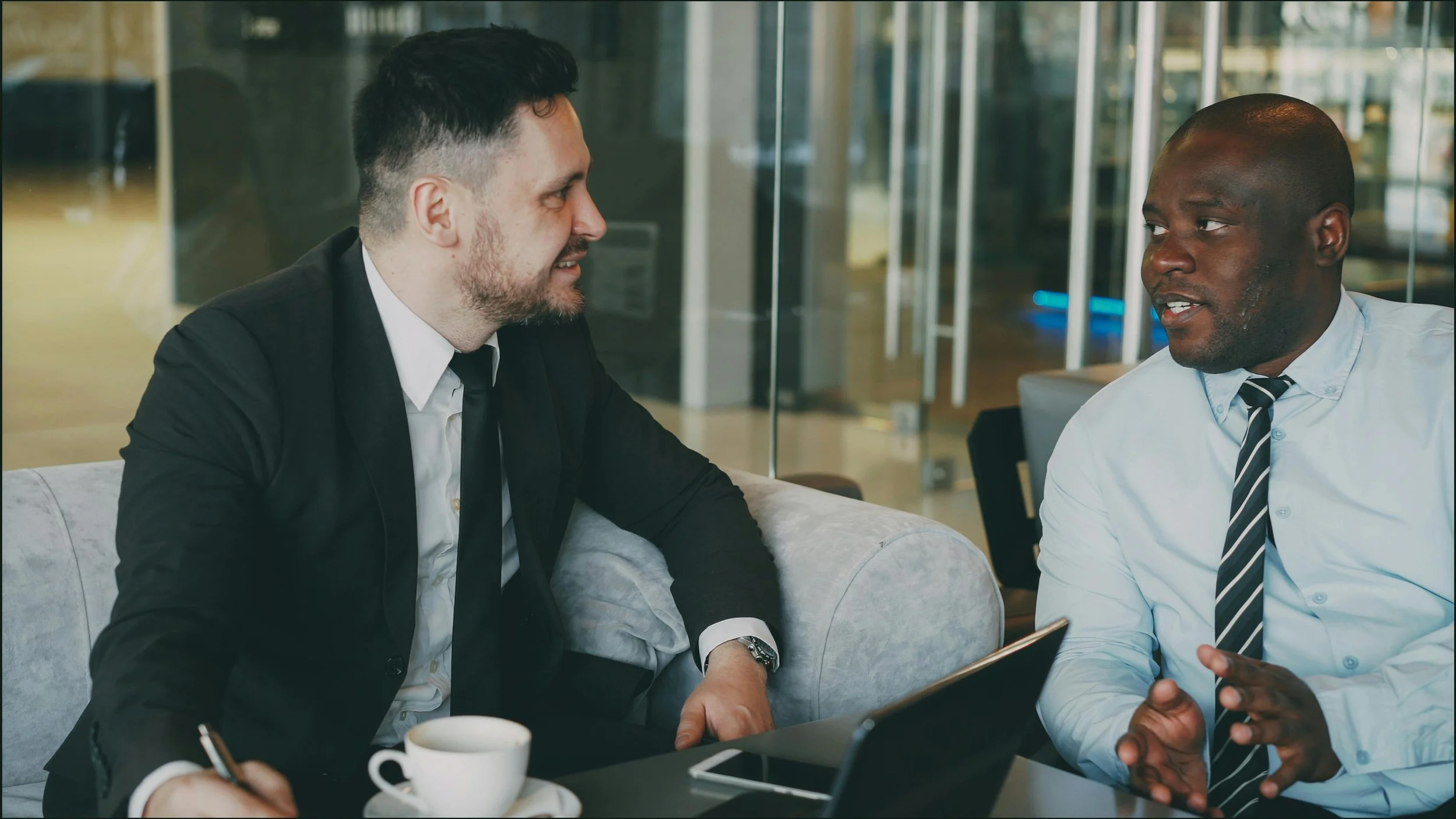 Two professionals having an initial business conversation in a relaxed setting.