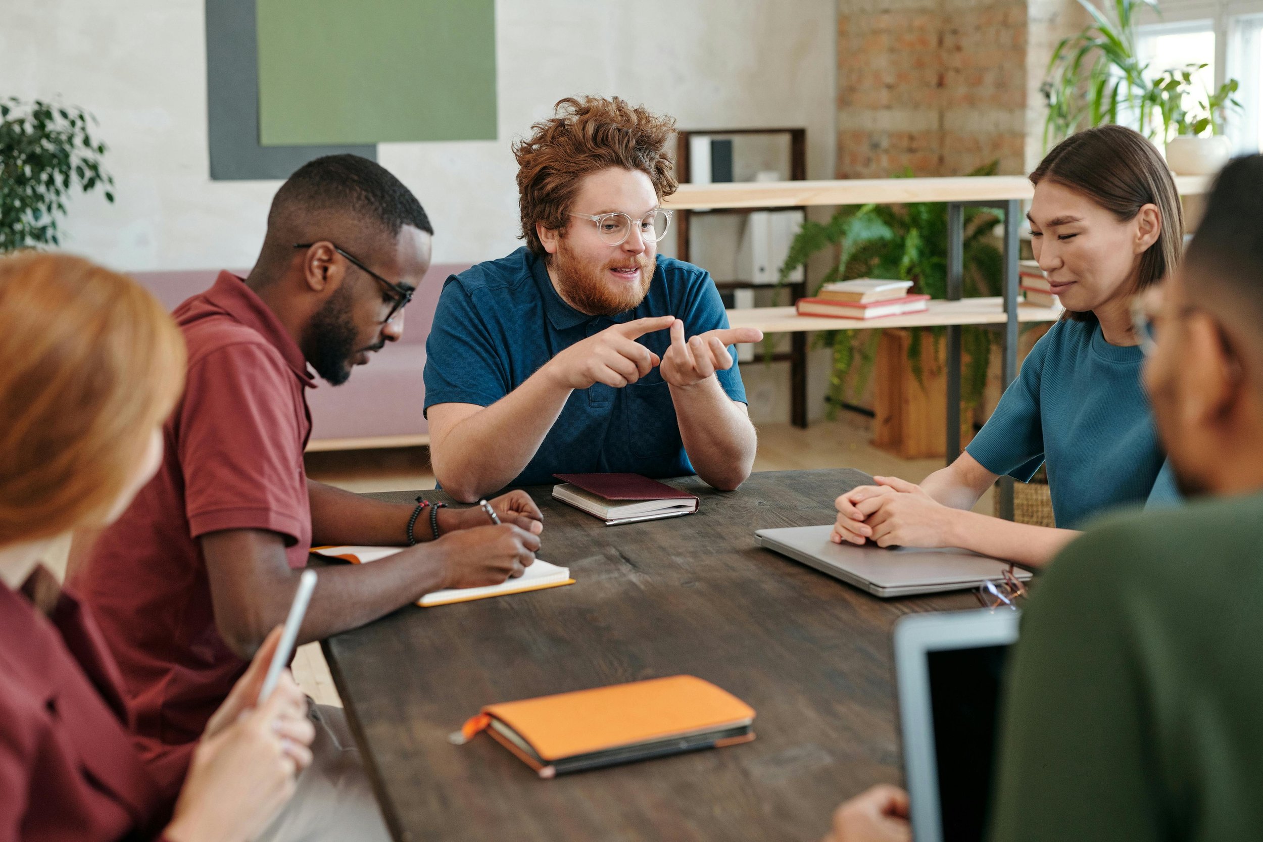 Salesperson having a thoughtful conversation with a potential client during a business meeting.