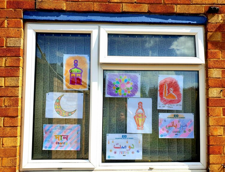 Lots of EID colouring sheets completed and placed in a window