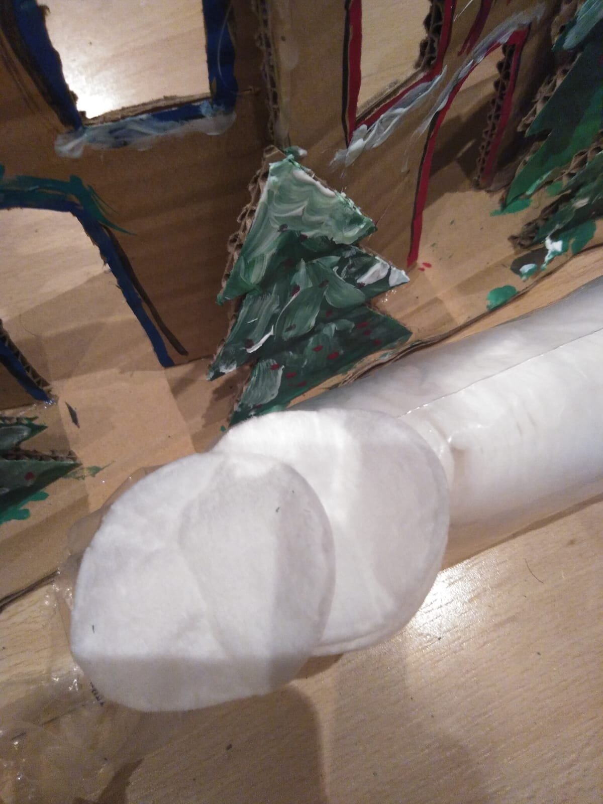 Using cotton wool to decorate a cardboard Christmas tree