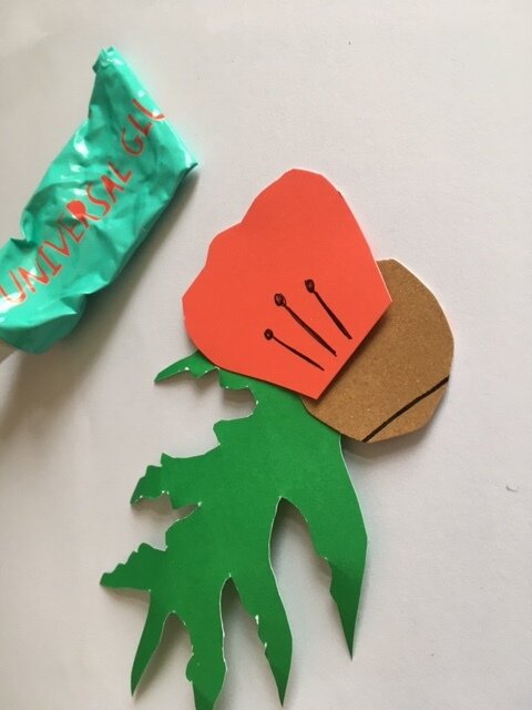 Gluing petals and leaves onto a paper poppy