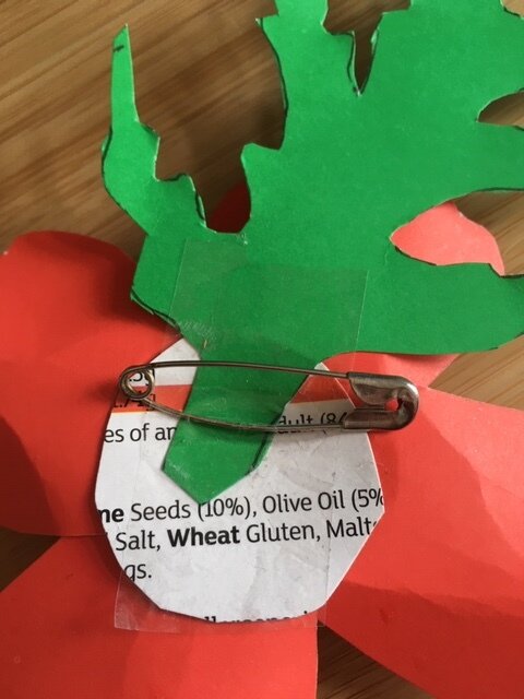 Safety pin on the reverse of a paper poppy