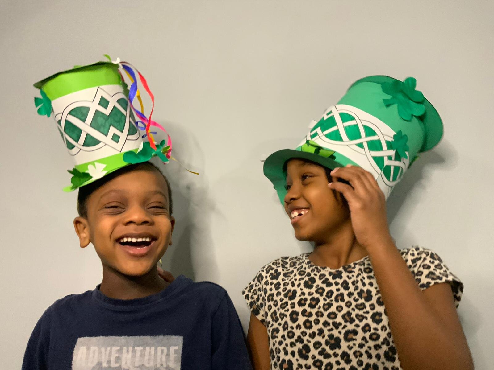 Children laughing in St Patrick’s Day carnival hats
