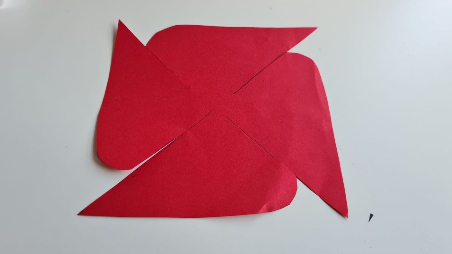 Cut out geometric poppy design on red paper