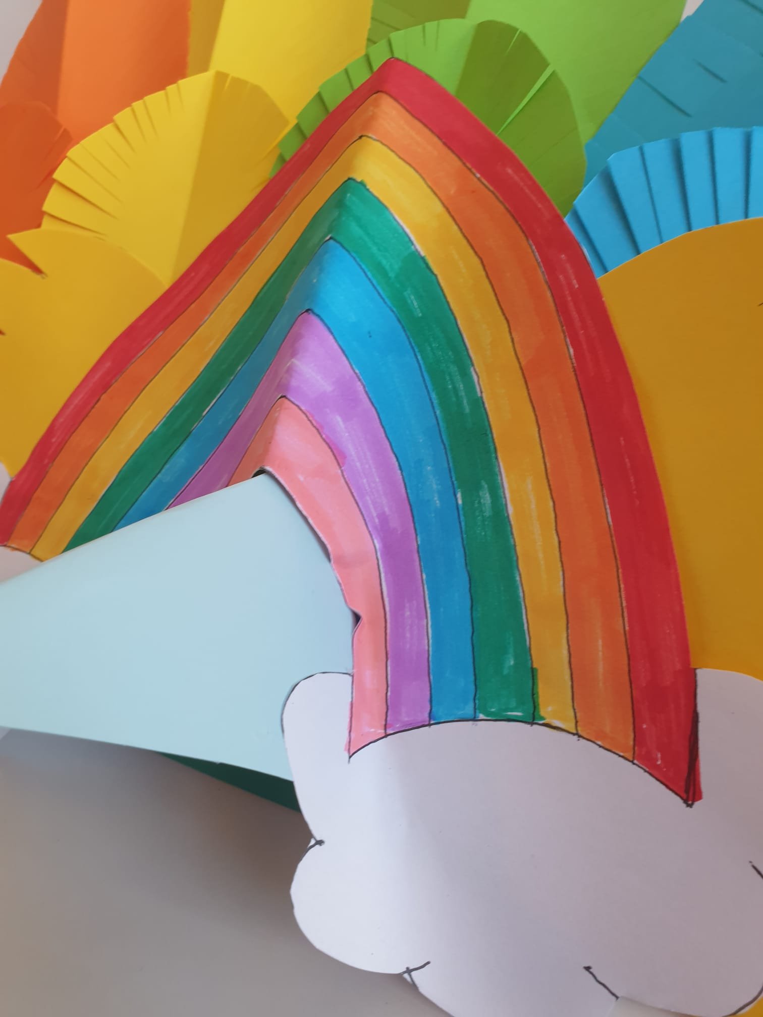 Paper rainbow stuck over the beak on the carnival headdress