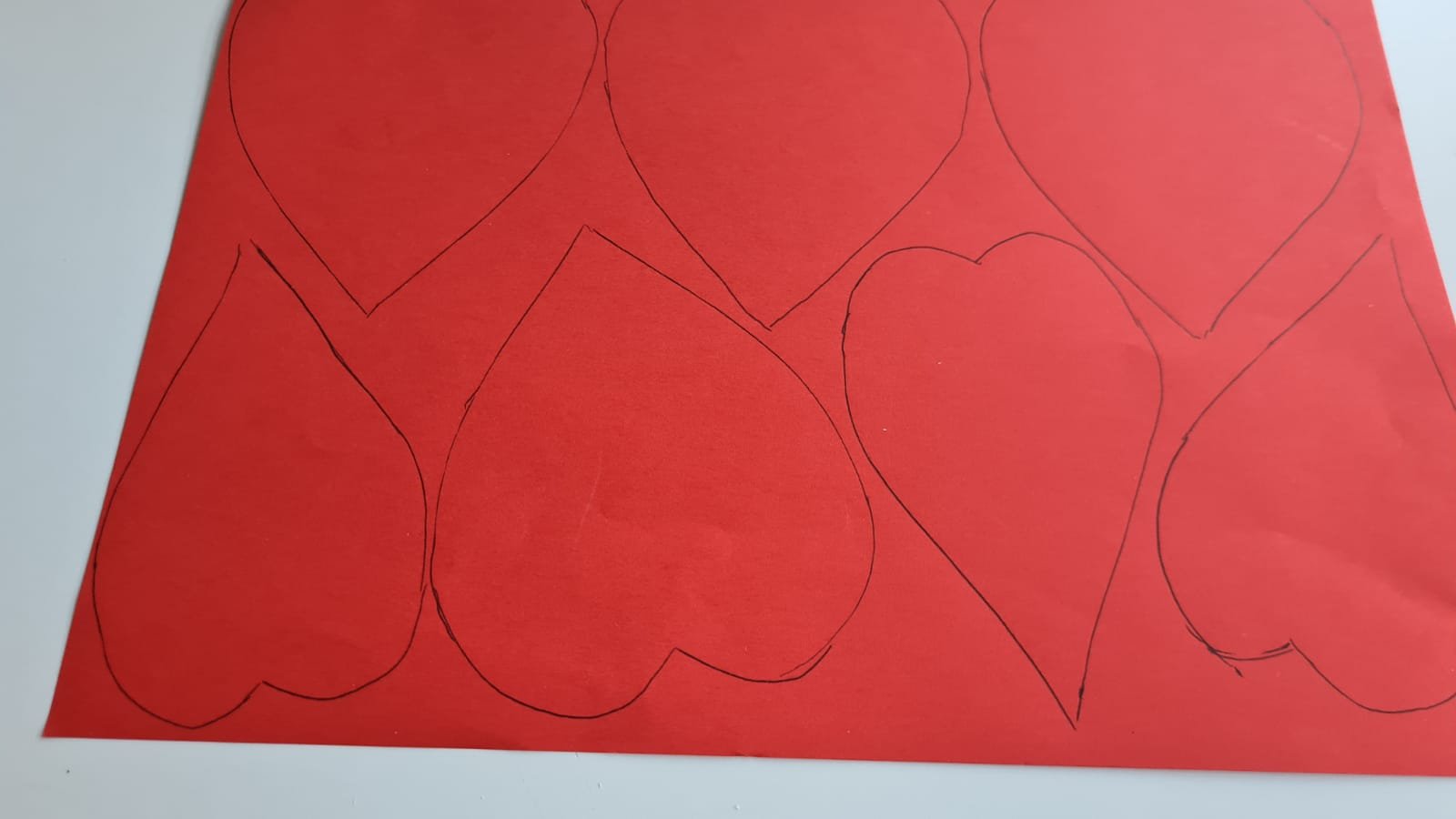 Hearts drawn on a red piece of paper