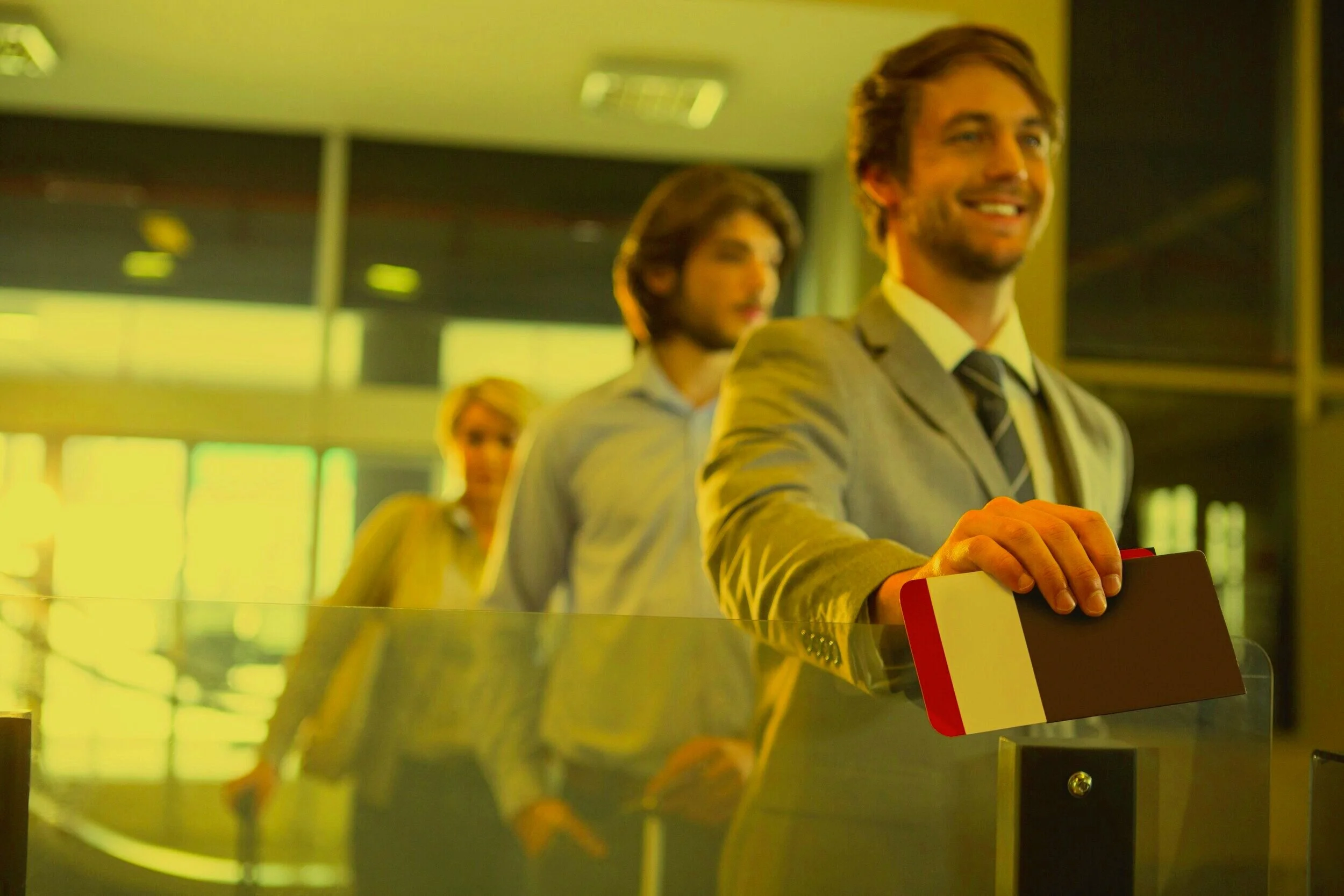 businessman-standing-with-boarding-pass-check-counter.jpg