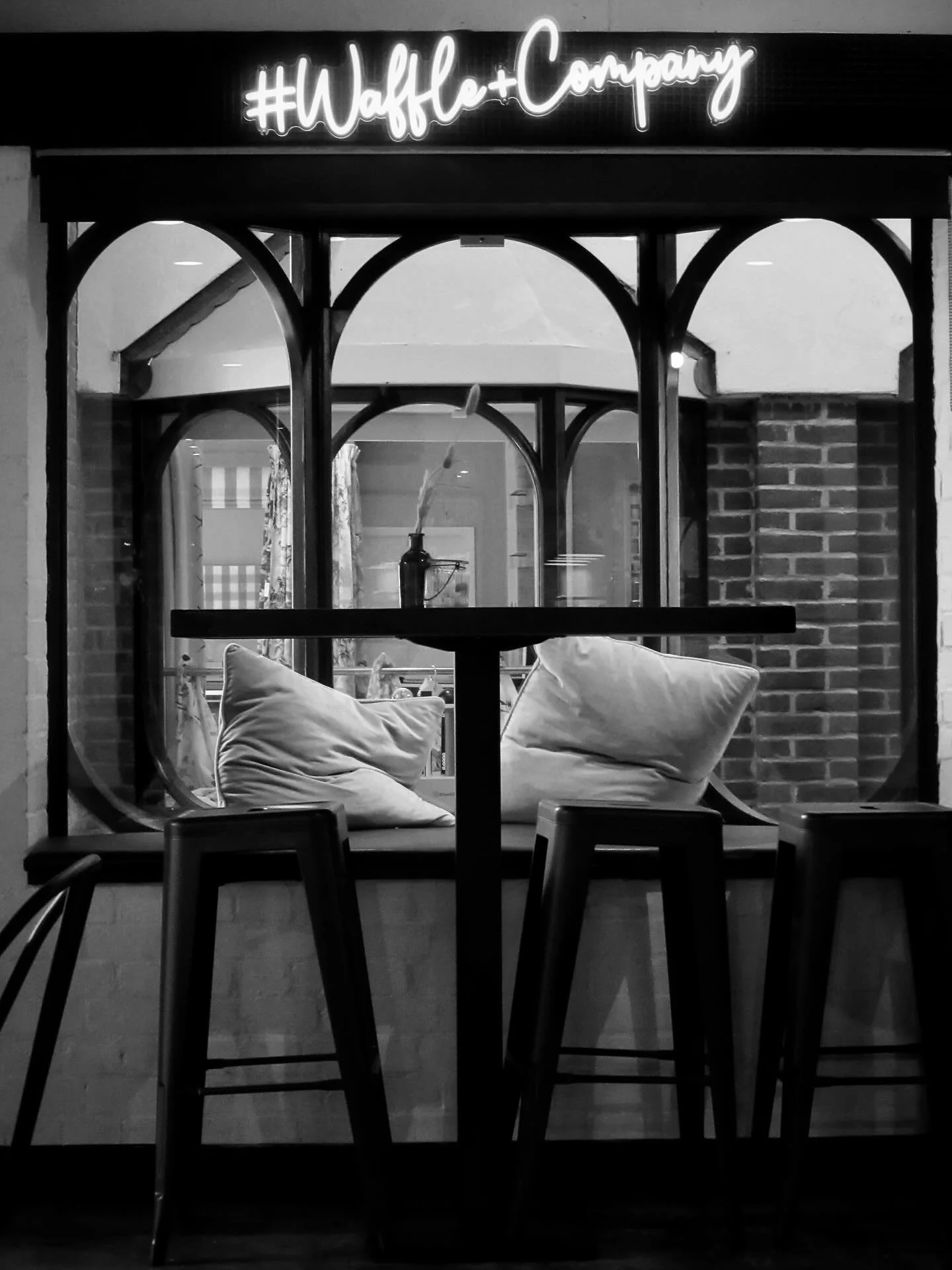 Our window seat, in black and white.
But full of colour, really.

It&rsquo;s where babies lie, lulled to sleep by the hum of conversation and the clink of coffee cups.
Where tired parents exhale, hands wrapped around something warm, for just a moment