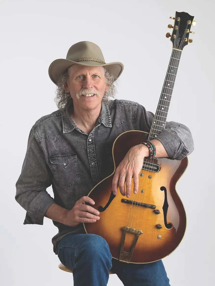 Photo of guitarist bruce forman with cowboy hat and guitar that belonged to barney kessel