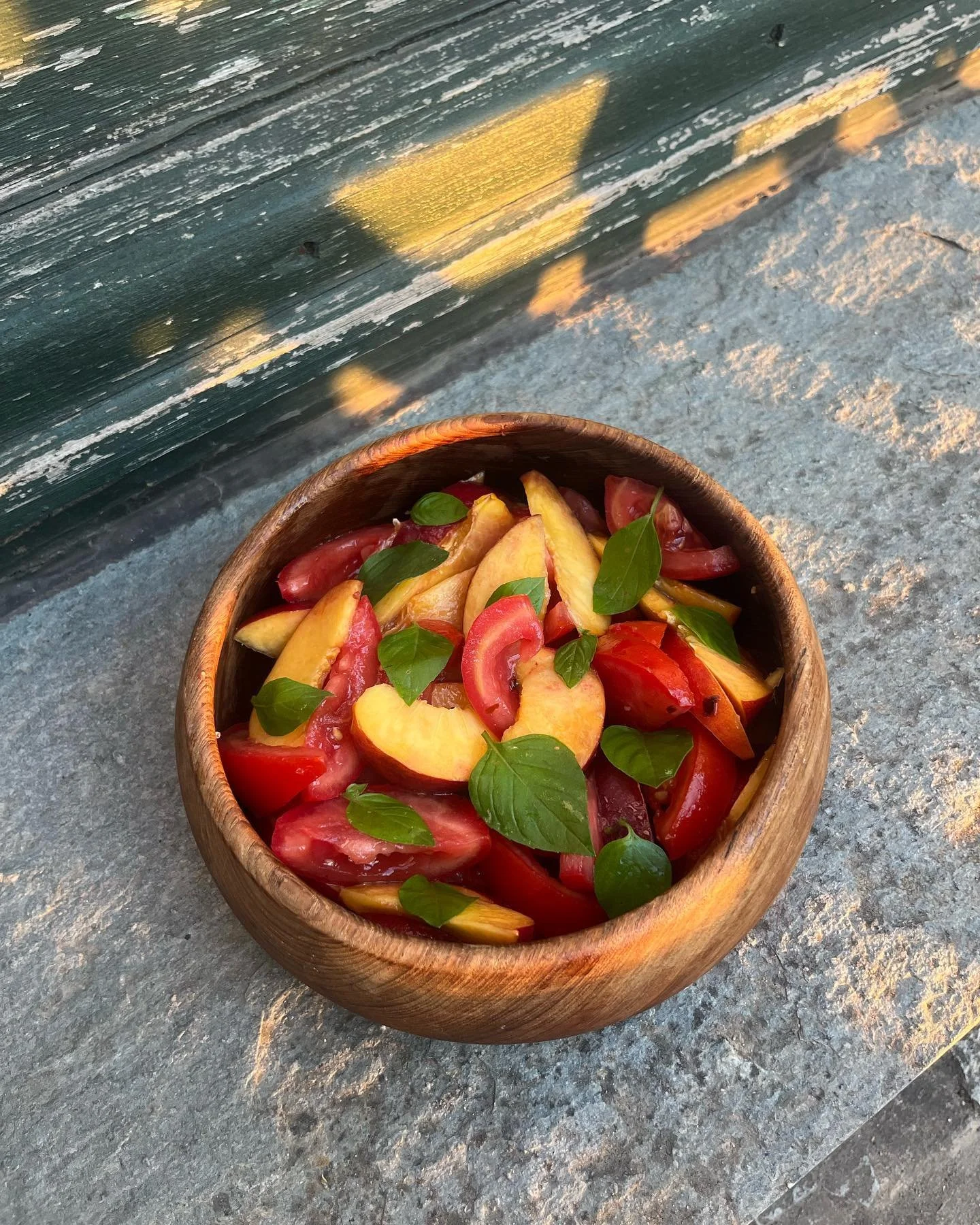Summer salad with fresh picks from our garden in Pelion, Greece: nectarine, tomato, thai basil and local olive oil 🌿