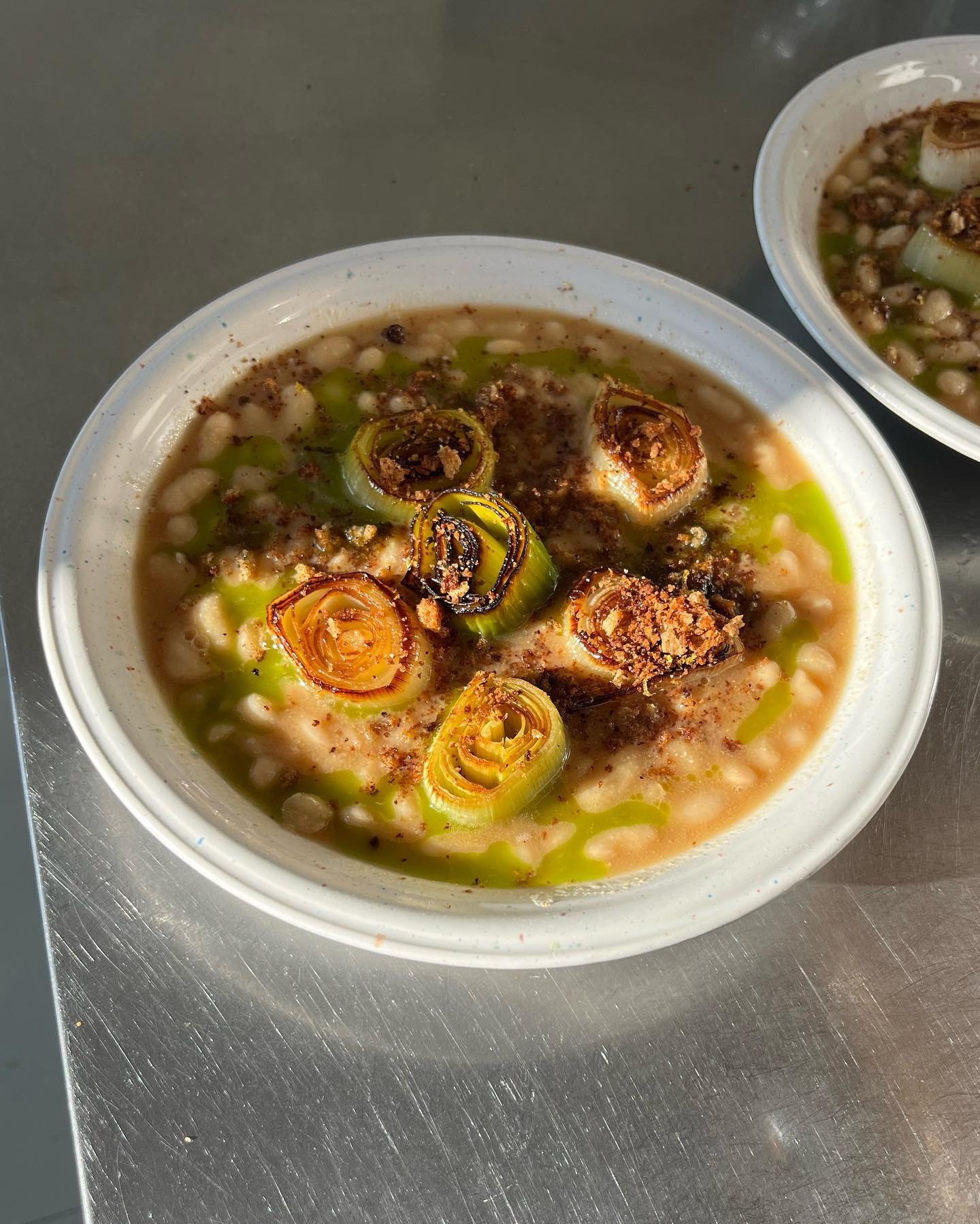 Dutch lemonbeans in miso broth with roasted leek, leek oil and lemon pangrattato.