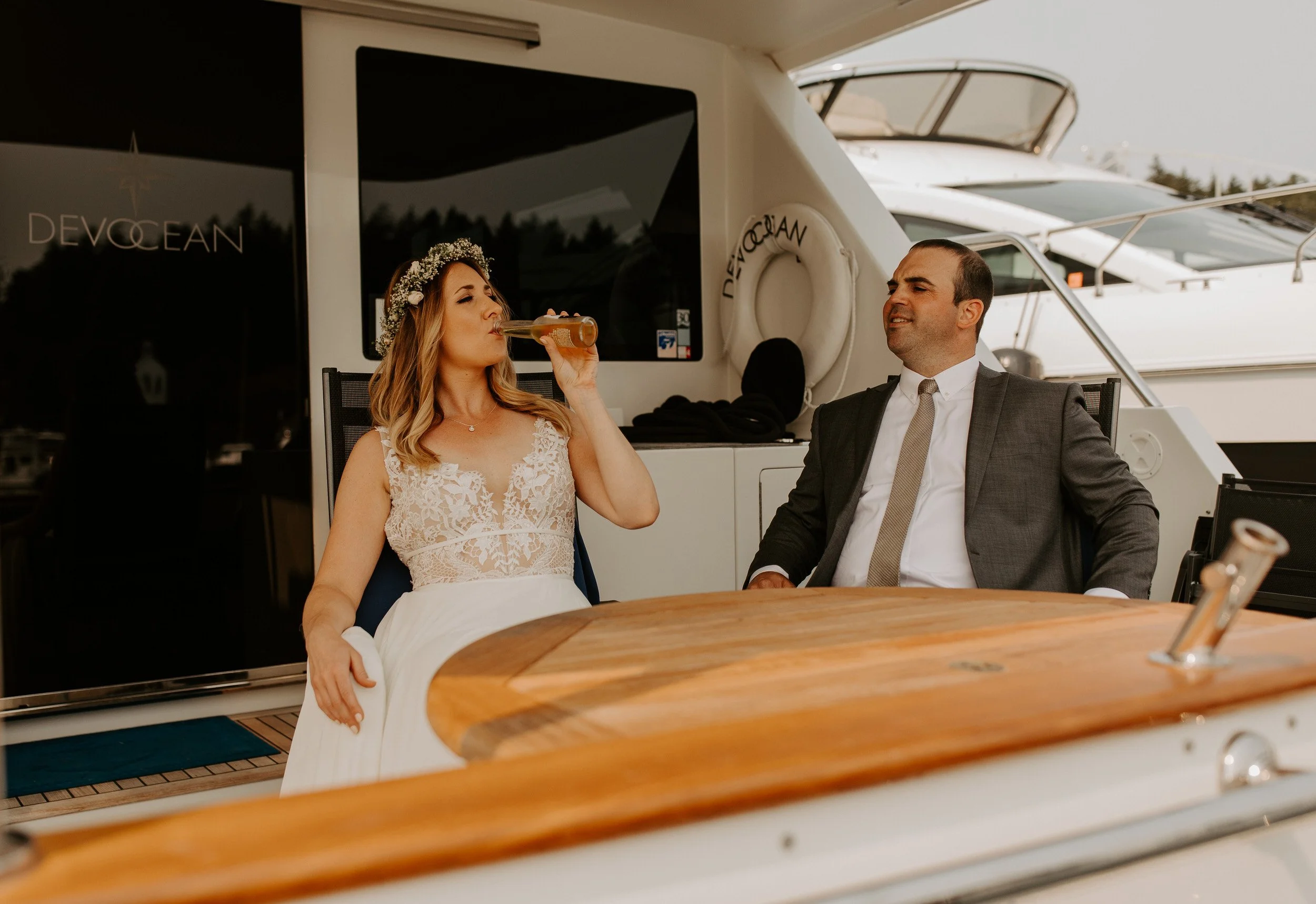 Bride and groom celebrating on a yacht in Roche Harbor during a San Juan Island elopement.
