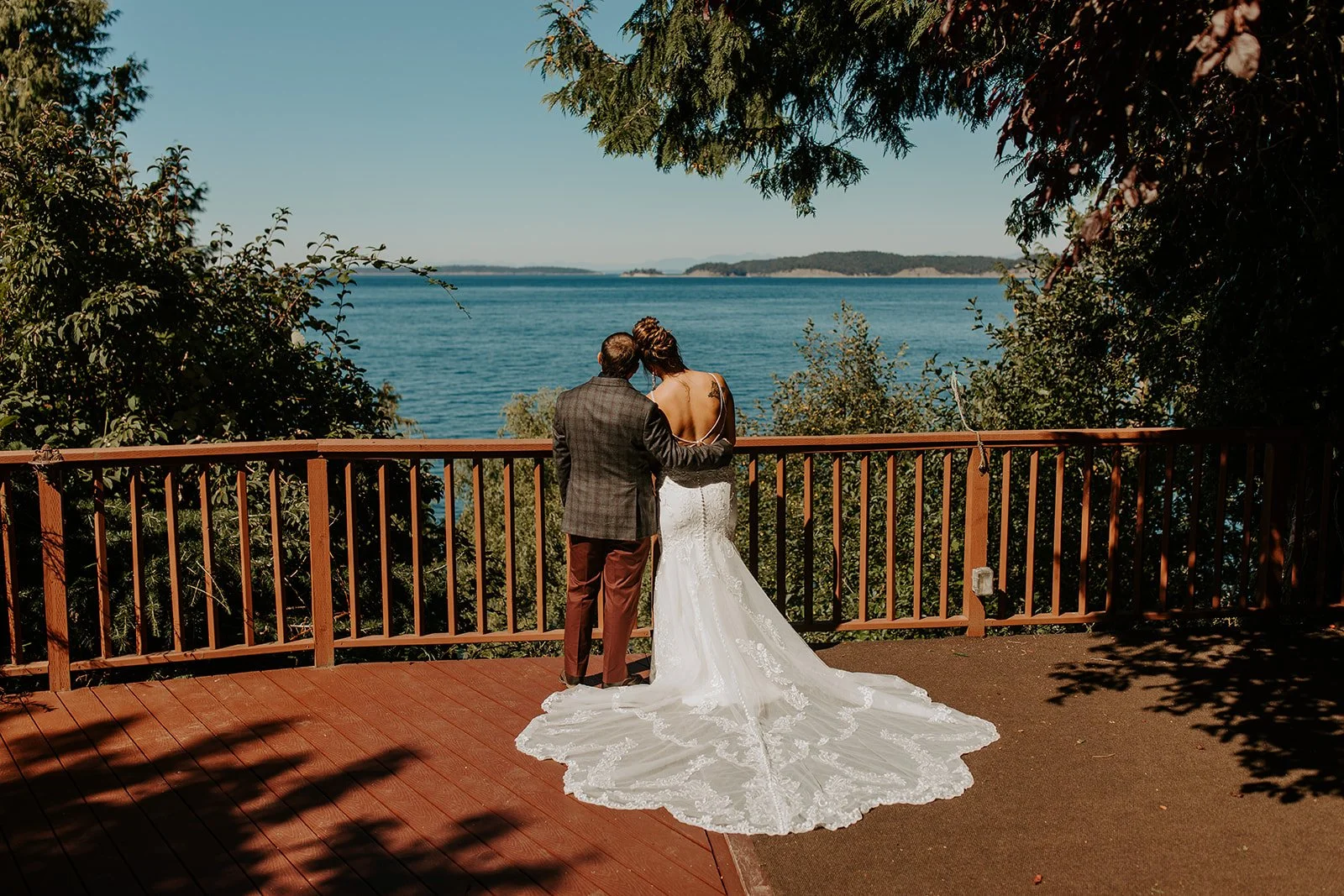 Bride and groom embracing on deck of their Orcas Island cabin in Eastsound.