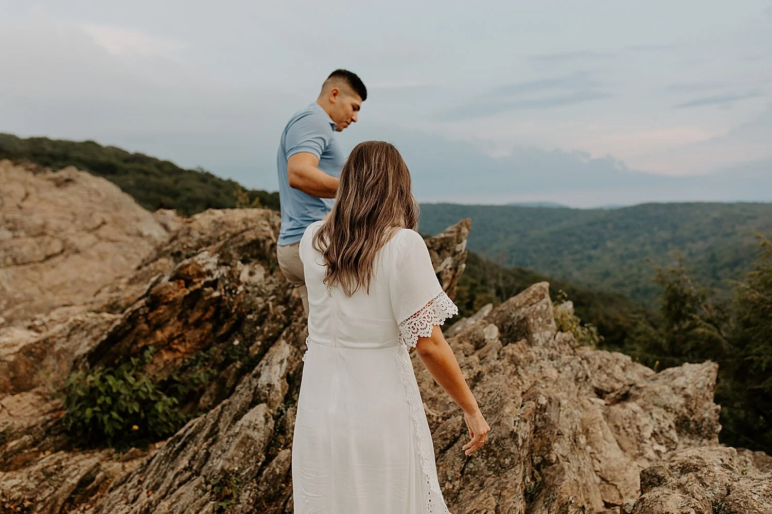 Couple walking along a rocky mountain overlook during their West Virginia elopement day.