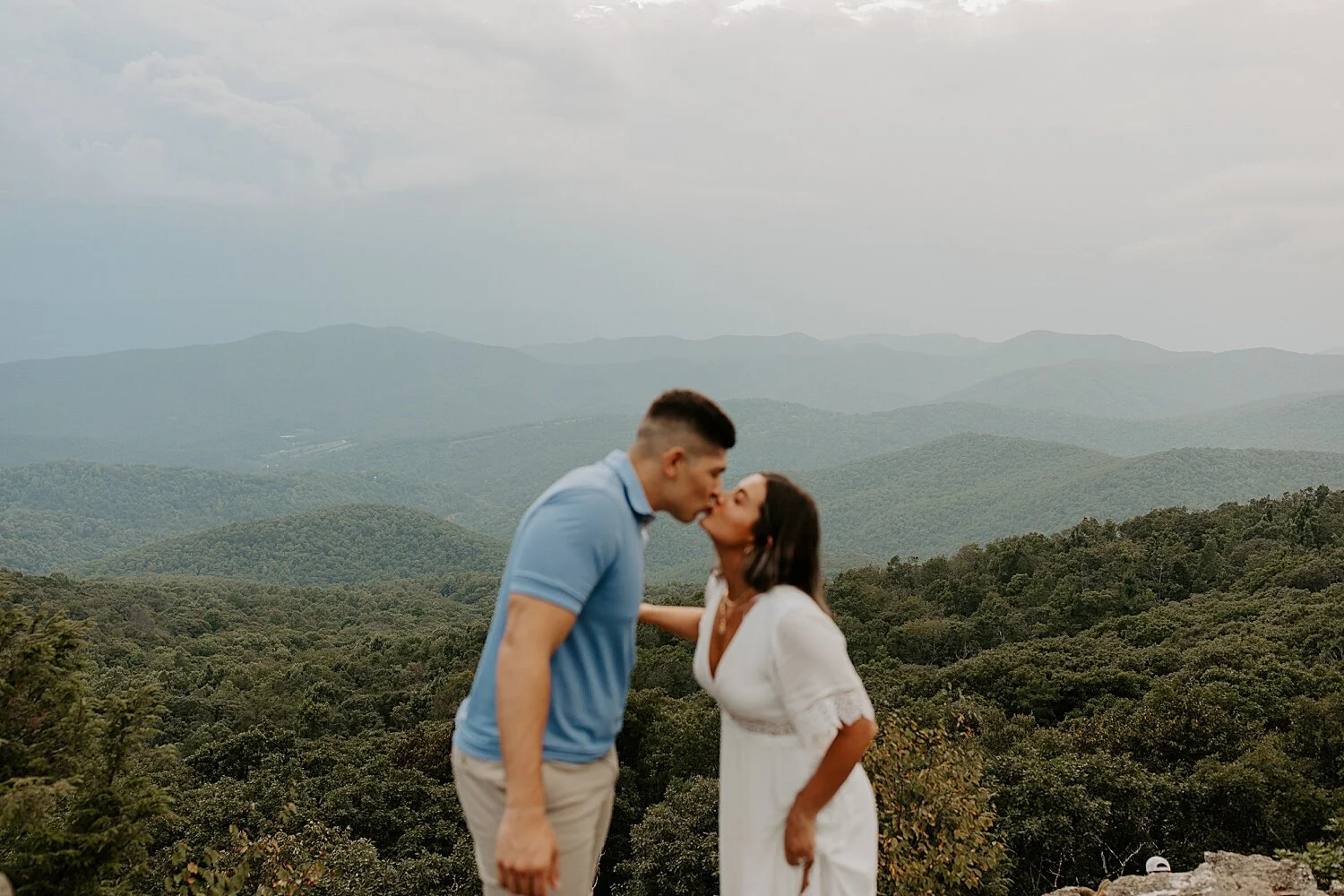 Couple kissing at a scenic mountain overlook during a West Virginia elopement.