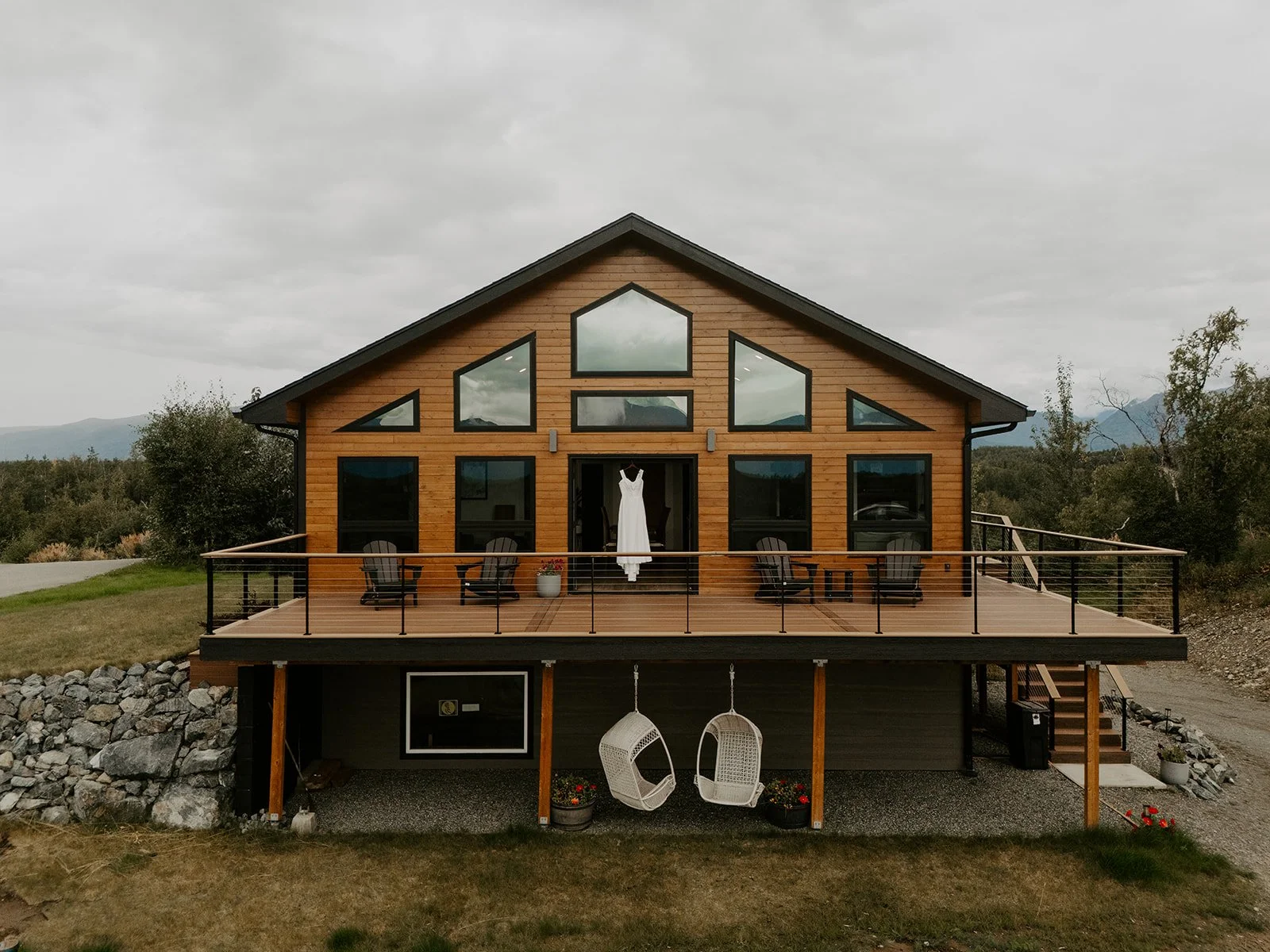 Modern mountain cabin in Palmer, Alaska with wedding dress hanging on the deck railing