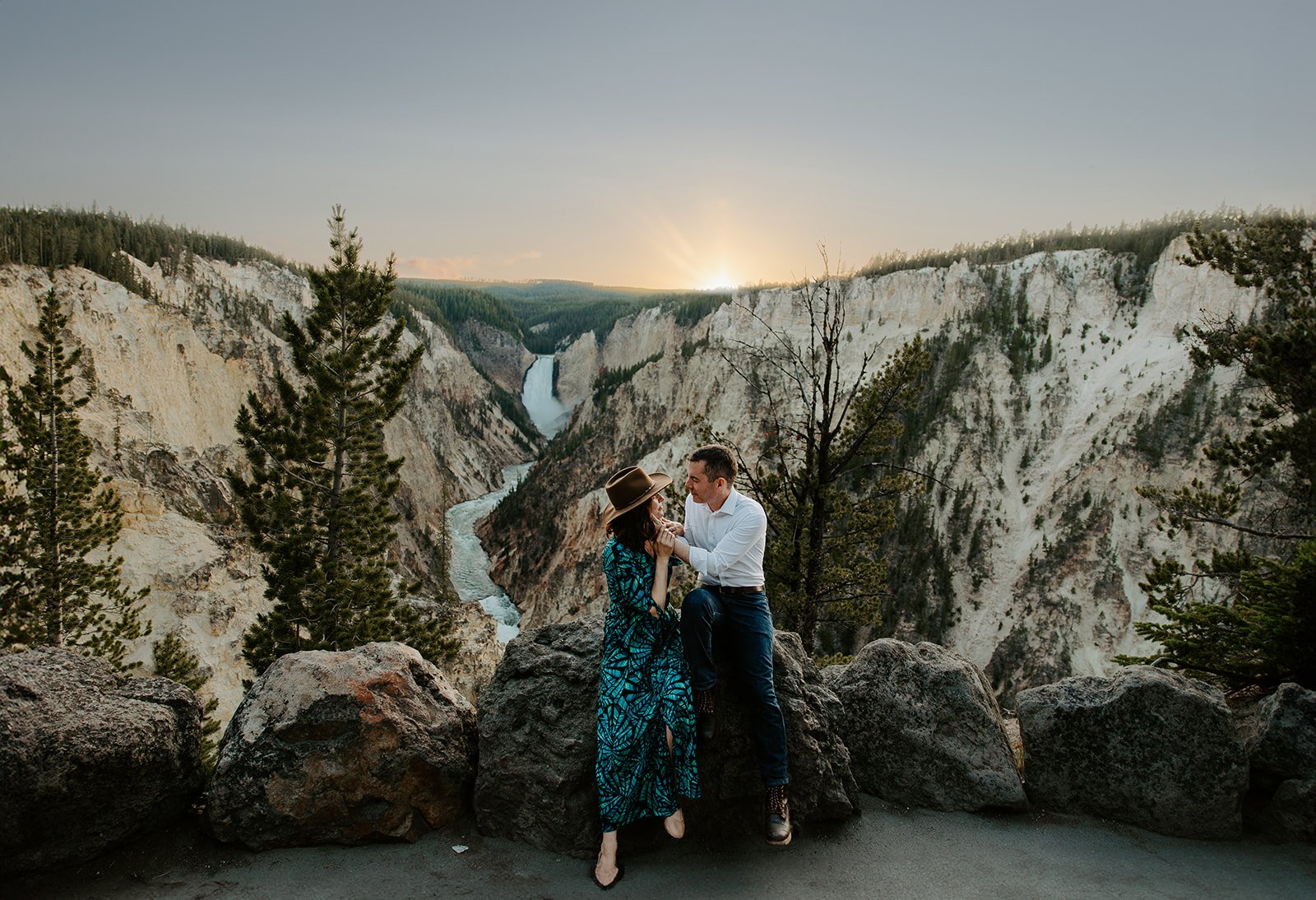 Couple sitting together at the scenic overlook at Artist Point above the Grand Canyon of the Yellowstone.