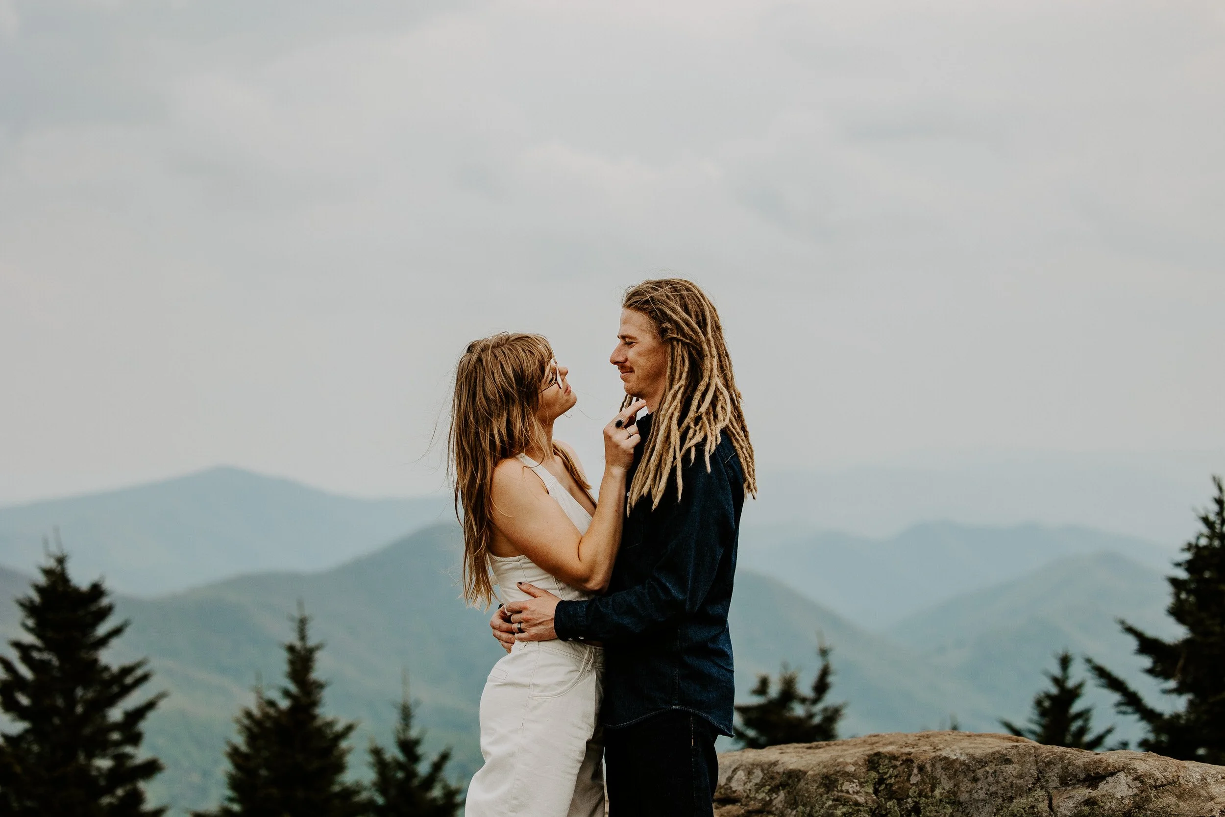 Couple embracing at a scenic mountain overlook during a West Virginia elopement.