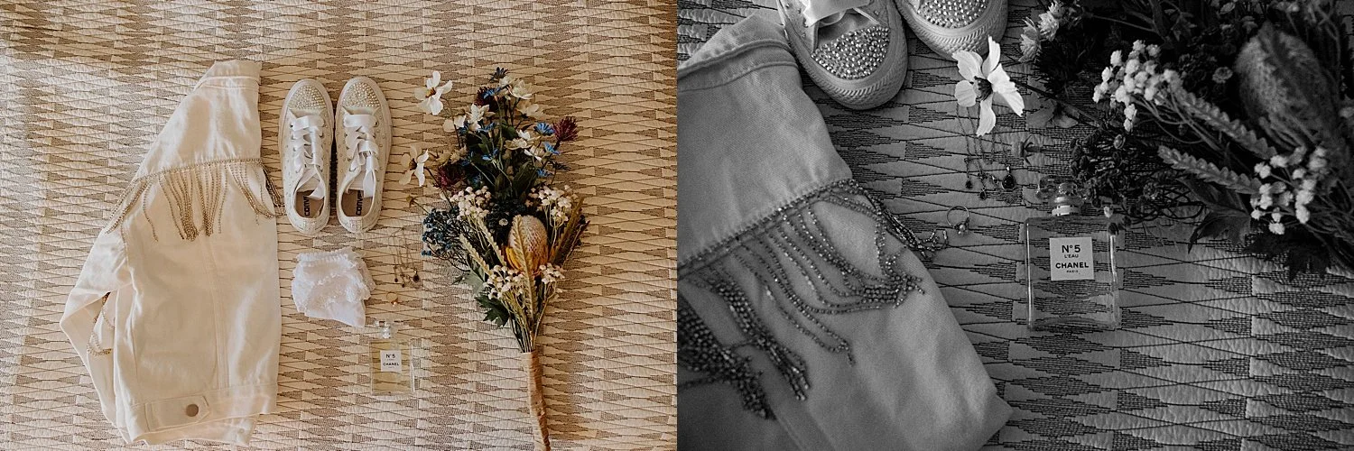 Bride details with an artificial floral bouquet, bedazzled white converse, white jean jacket with sparkly fringe, Chanel N°5 perfume, and jewelry