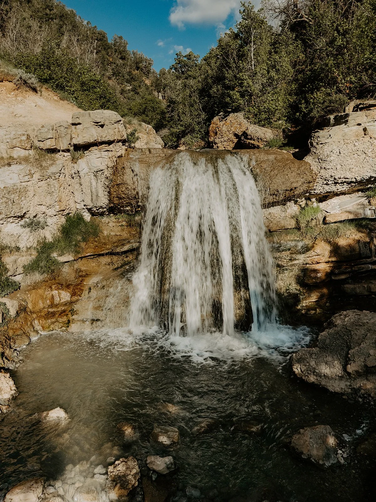 Waterfall flowing into hot spring pools at Fifth Water Hot Springs in Diamond Fork Canyon, Utah