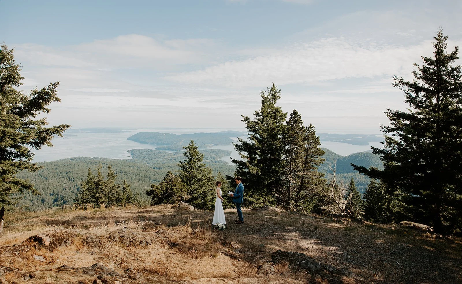 Couple exchanging vows at Little Summit in Moran State Park during Orcas Island elopement